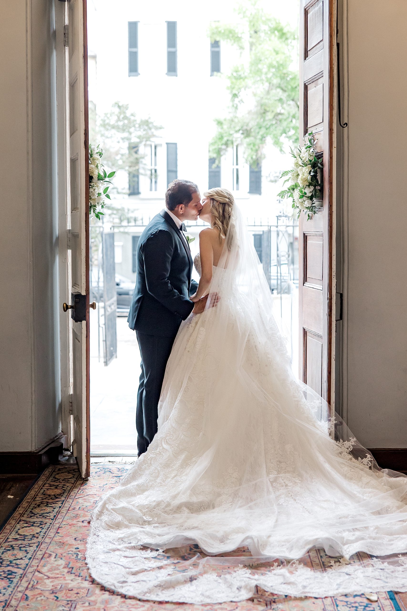 newlyweds kiss in the doorway of church