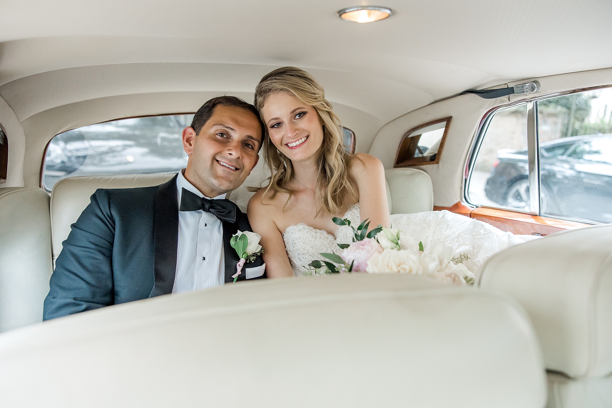 couple sit inside classic car after Romantic Charleston Wedding