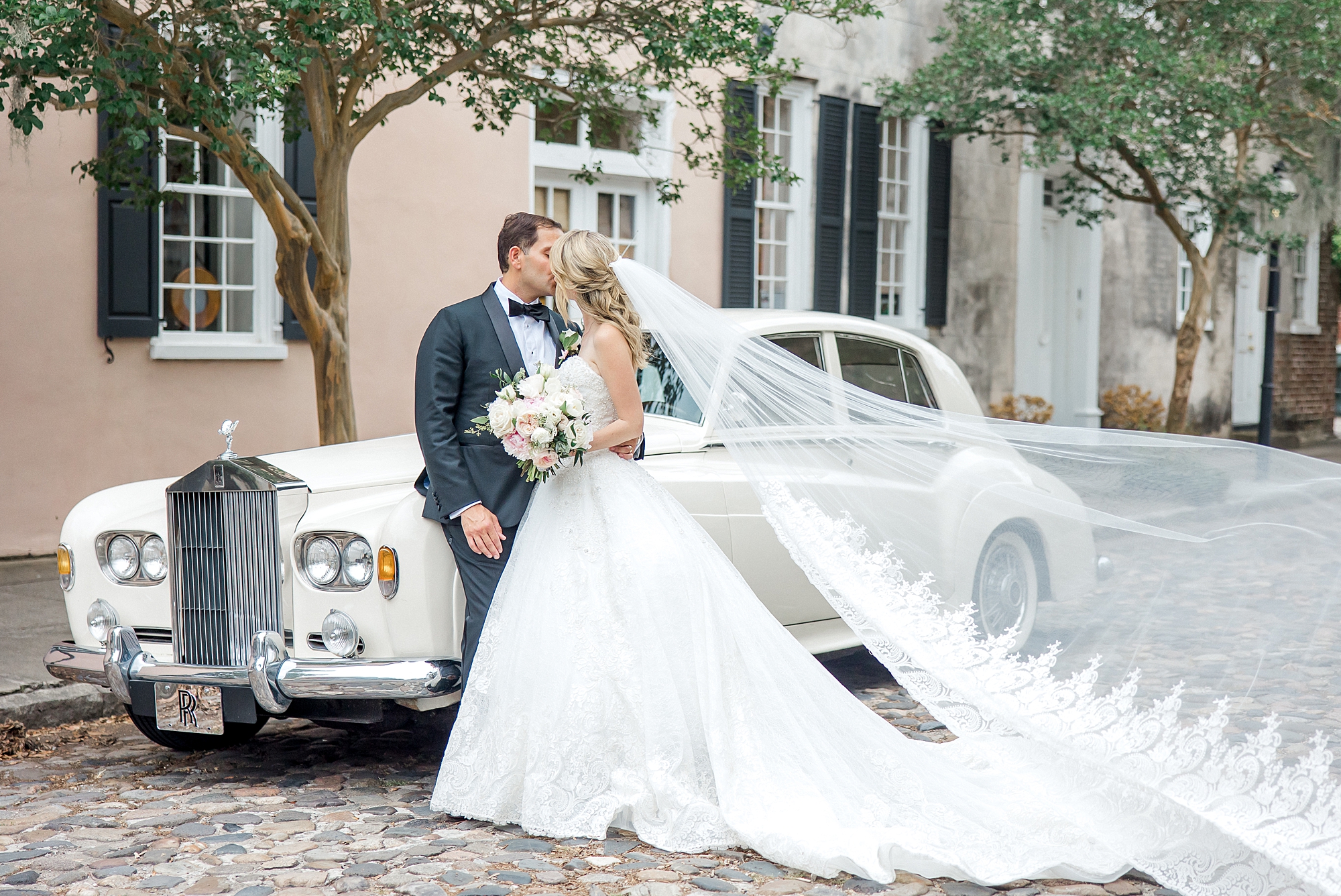 newlyweds in front of classic car