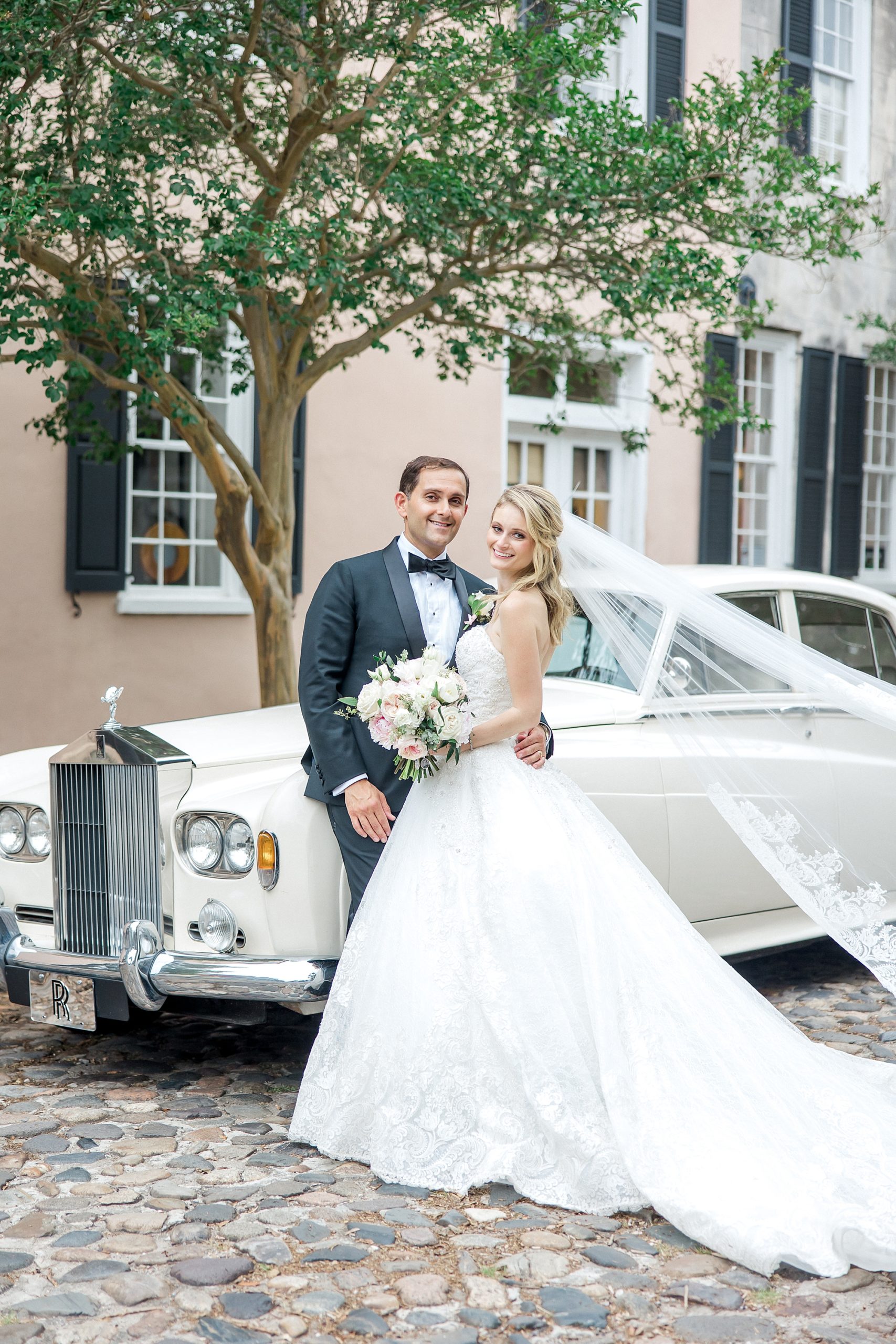 newlyweds in downtown Charleston by Rolls Royce