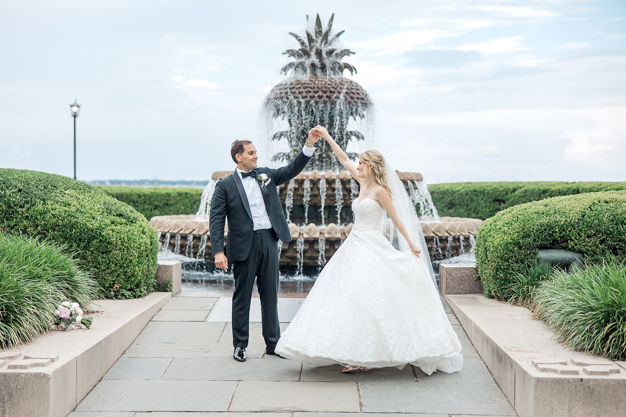 couple dance in front of pineapple fountain in downtown Charleston SC