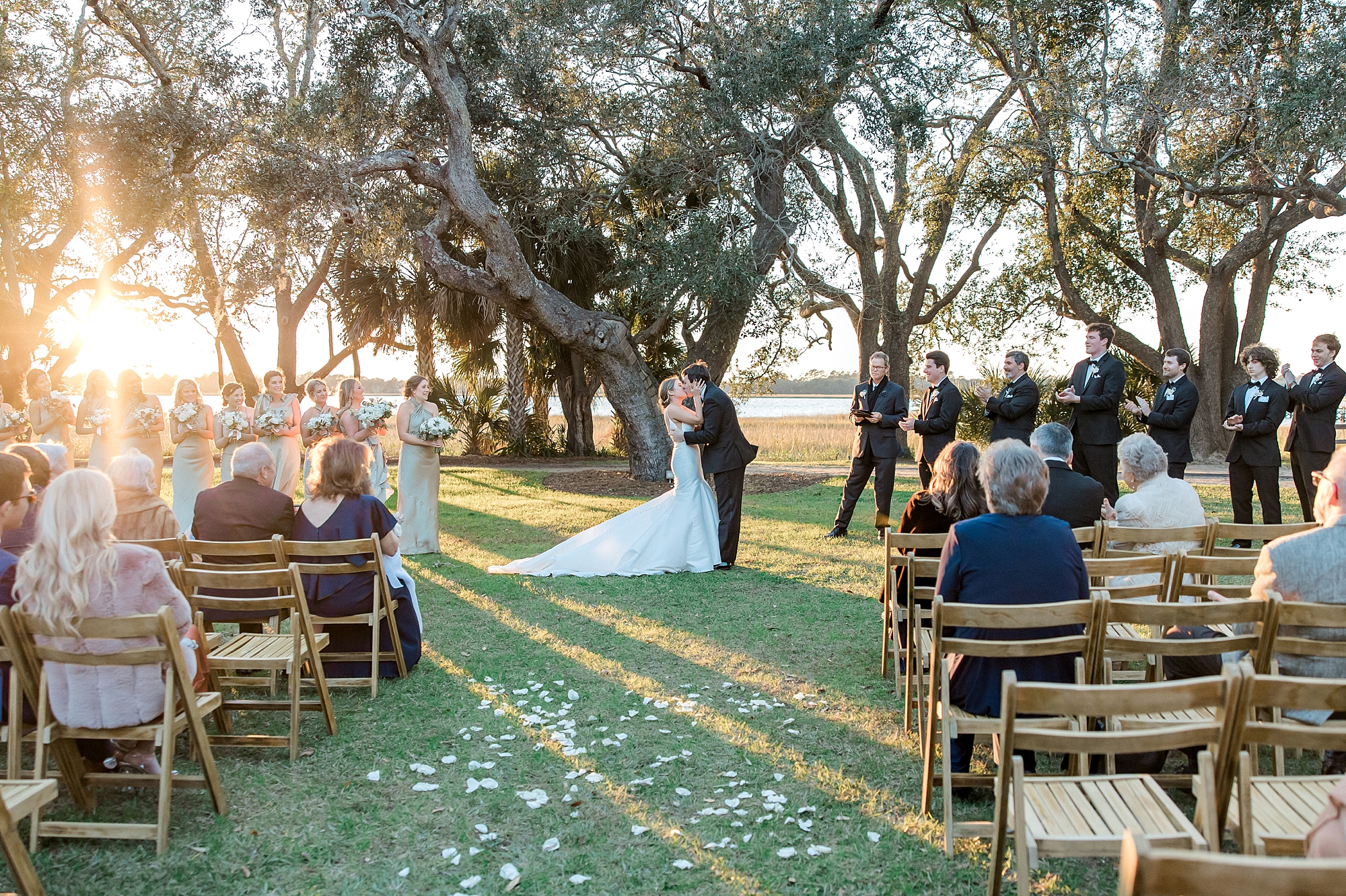 couple kiss during Lowndes Grove Winter Wedding ceremony
