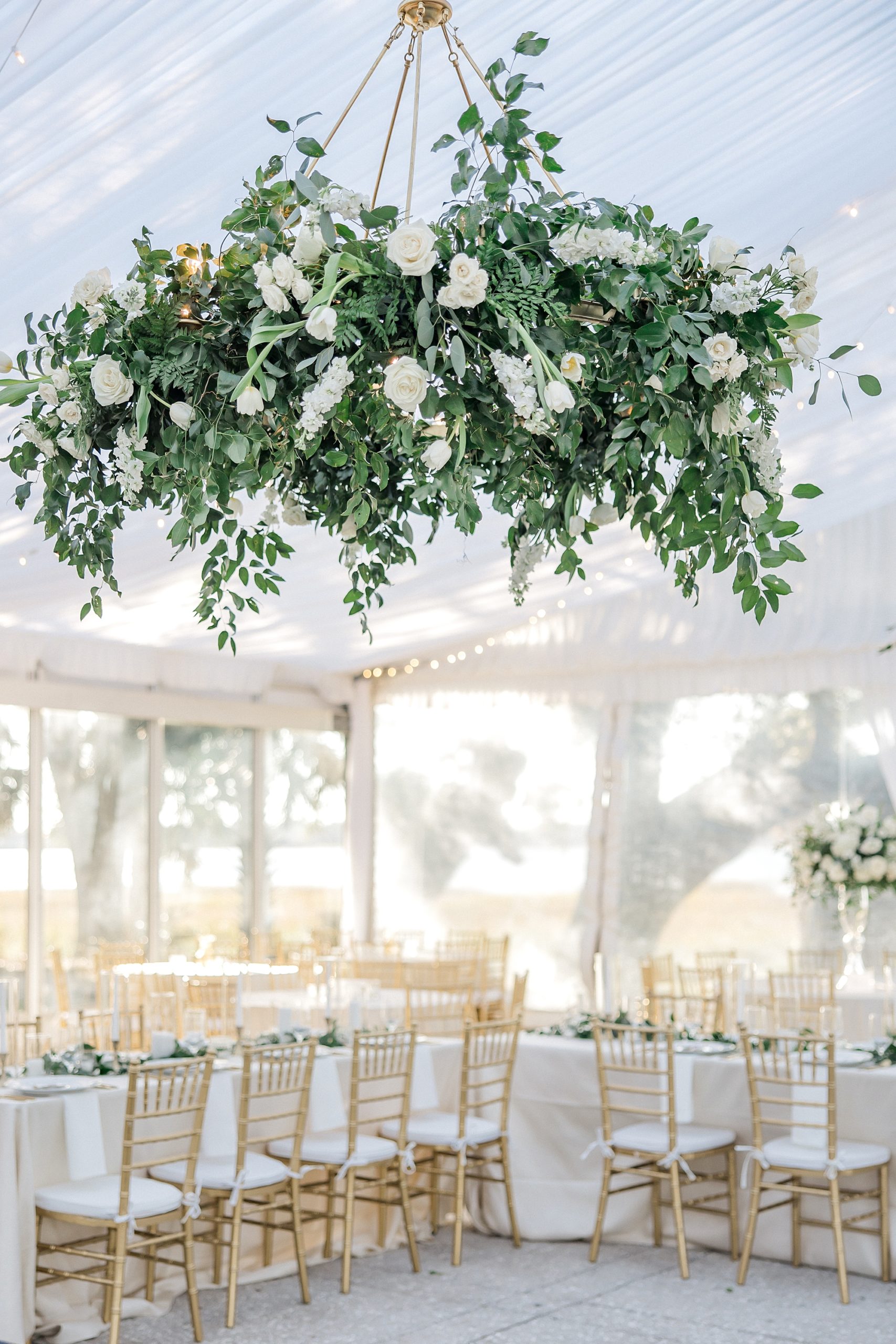 white flowers and greenery hang from ceiling at Lowndes Grove Winter Wedding