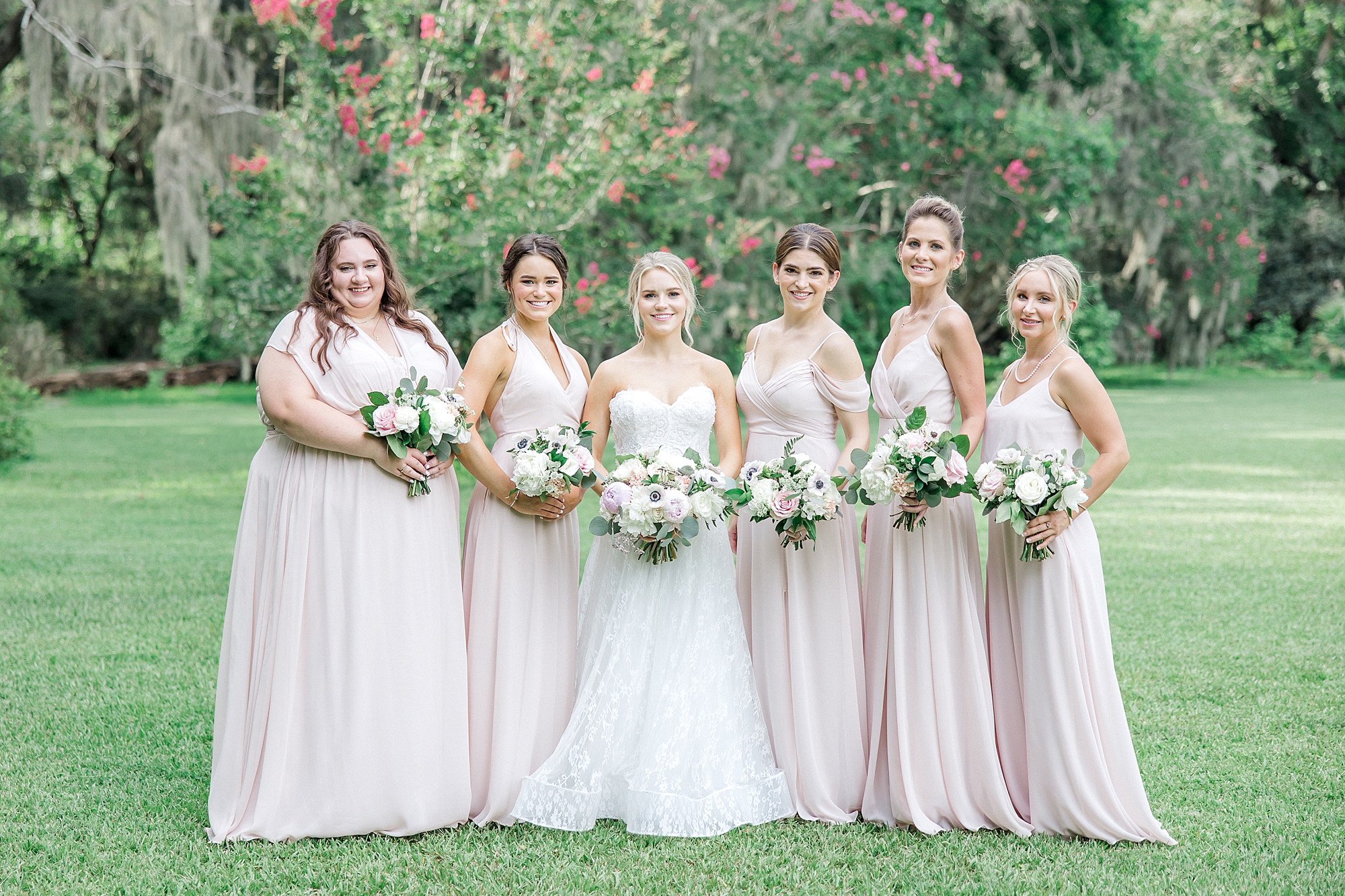 bride and bridesmaids in blush pink dresses