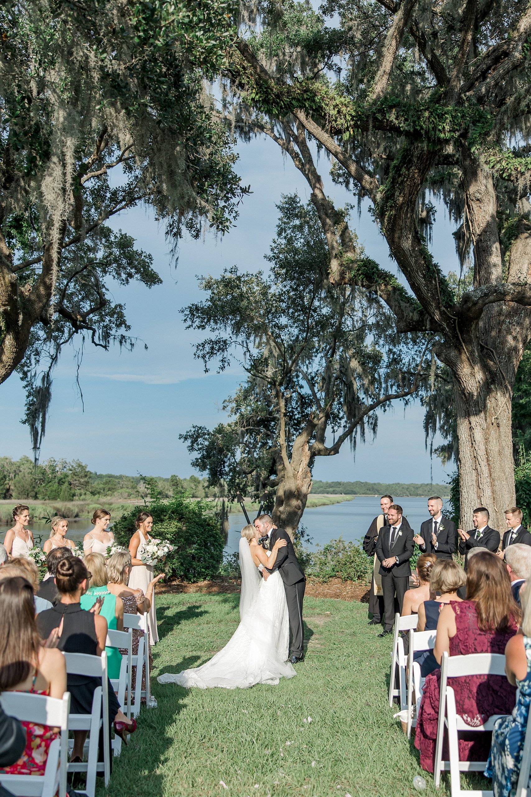 bride and groom kiss at Summer Carriage House Wedding at Magnolia Plantation and Gardens