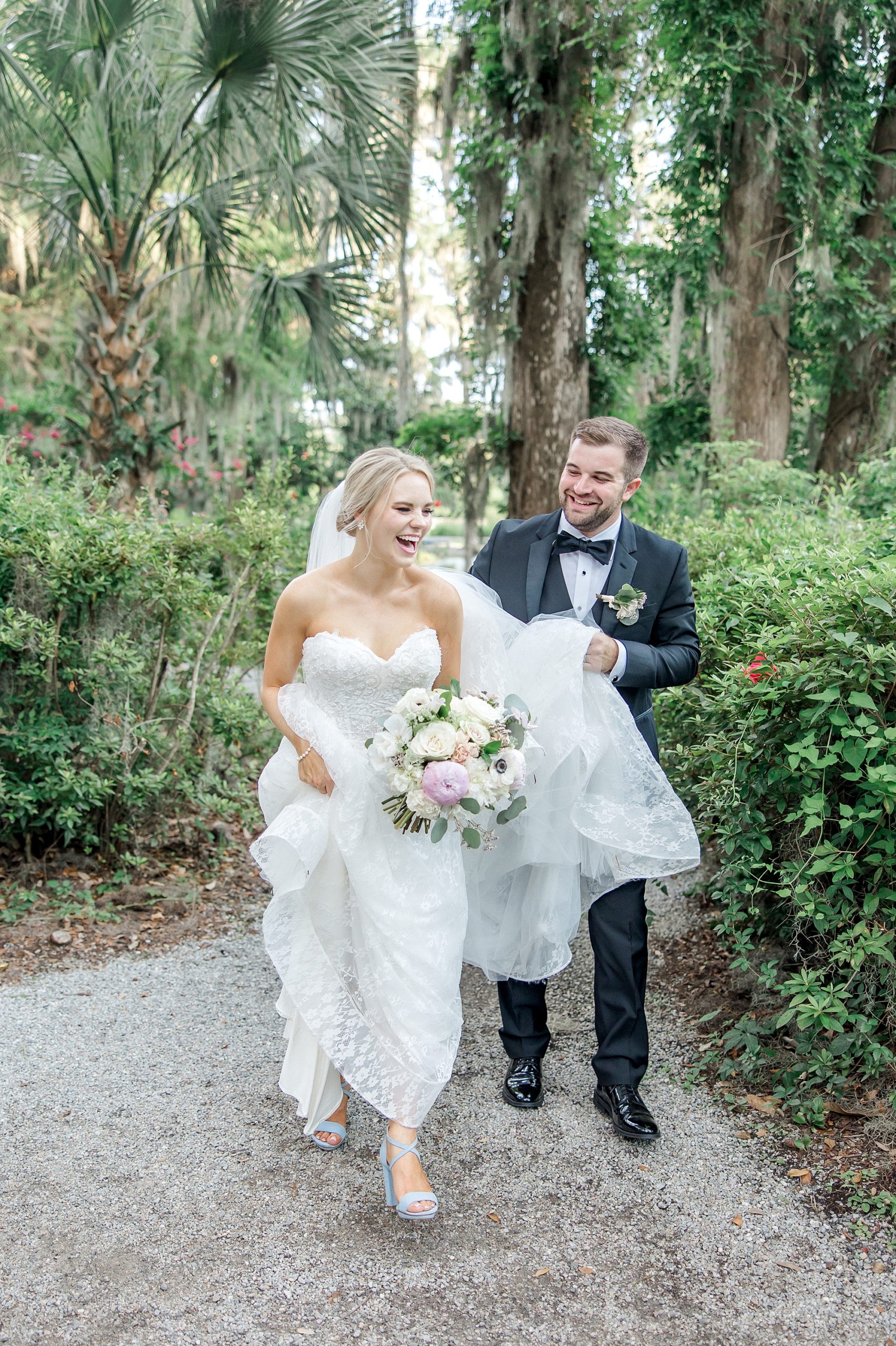 groom helps bride with dress