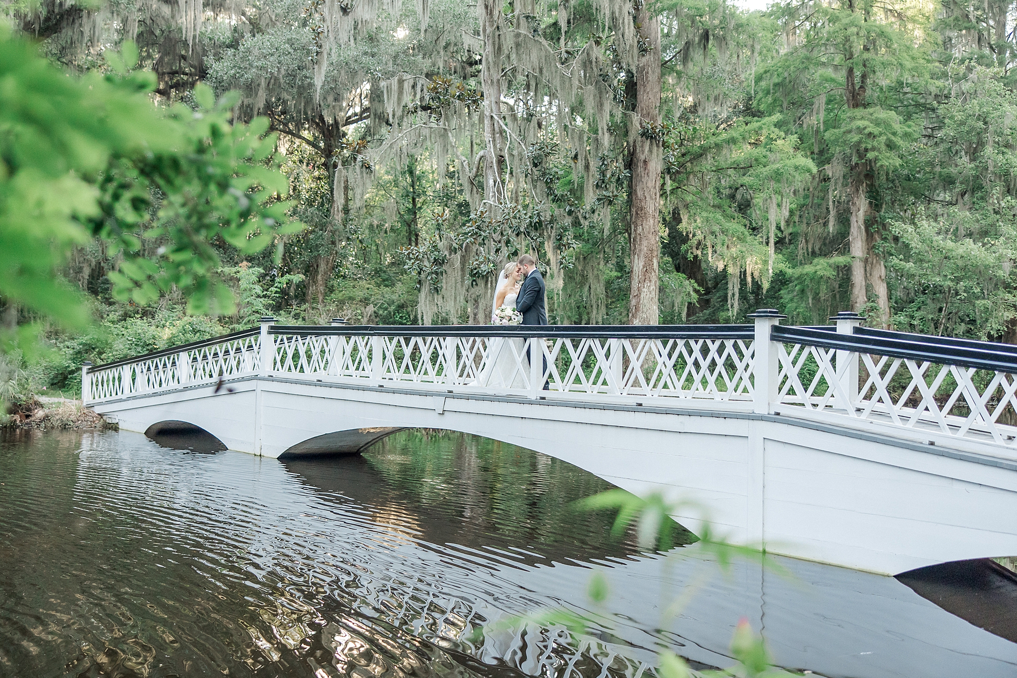 romantic wedding portraits on white bridge in Charleston, SC