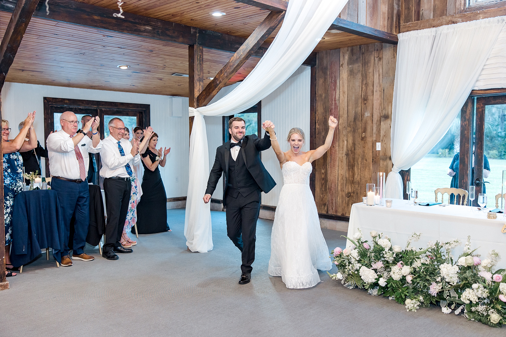 newlyweds enter wedding reception at The Carriage House
