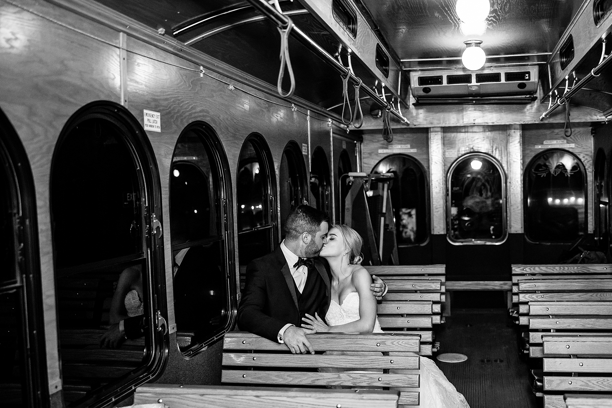 newlyweds kiss as they leave their Summer Carriage House Wedding reception
