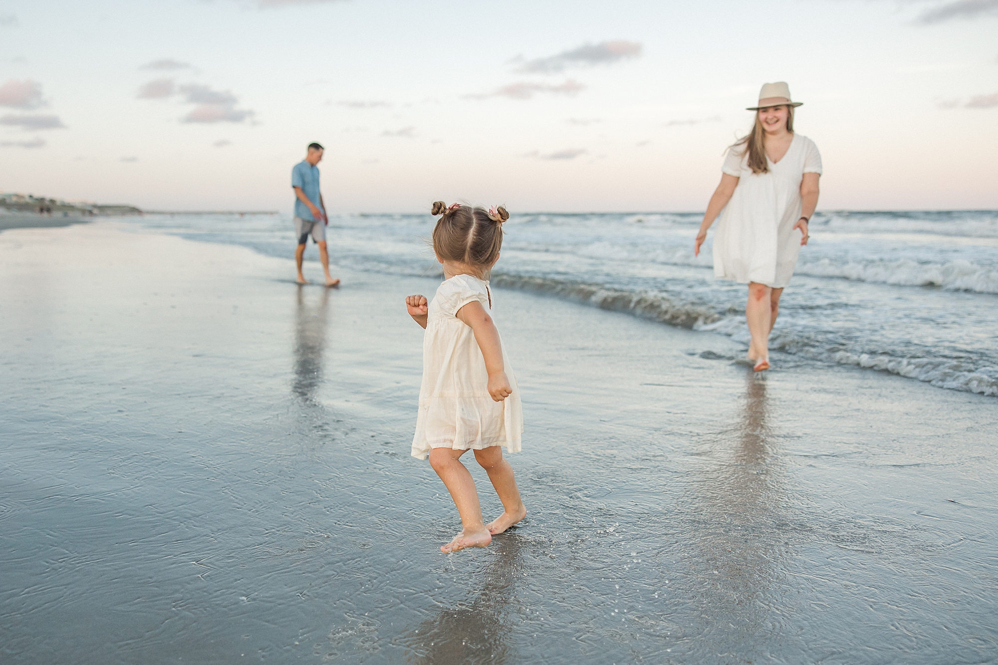 little girl runs down the beach
