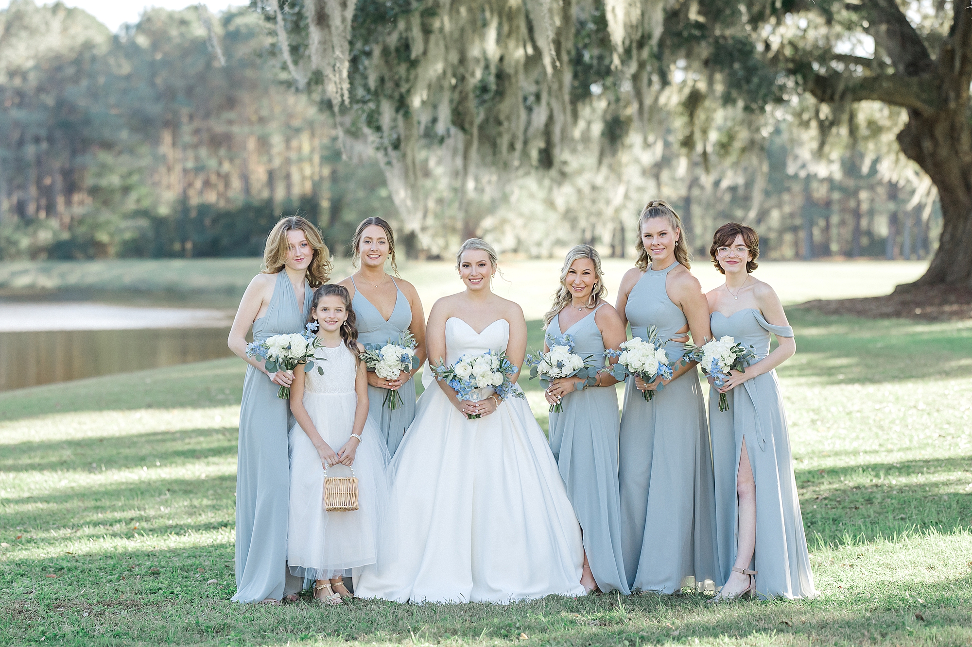 bride with bridesmaids under live oaks