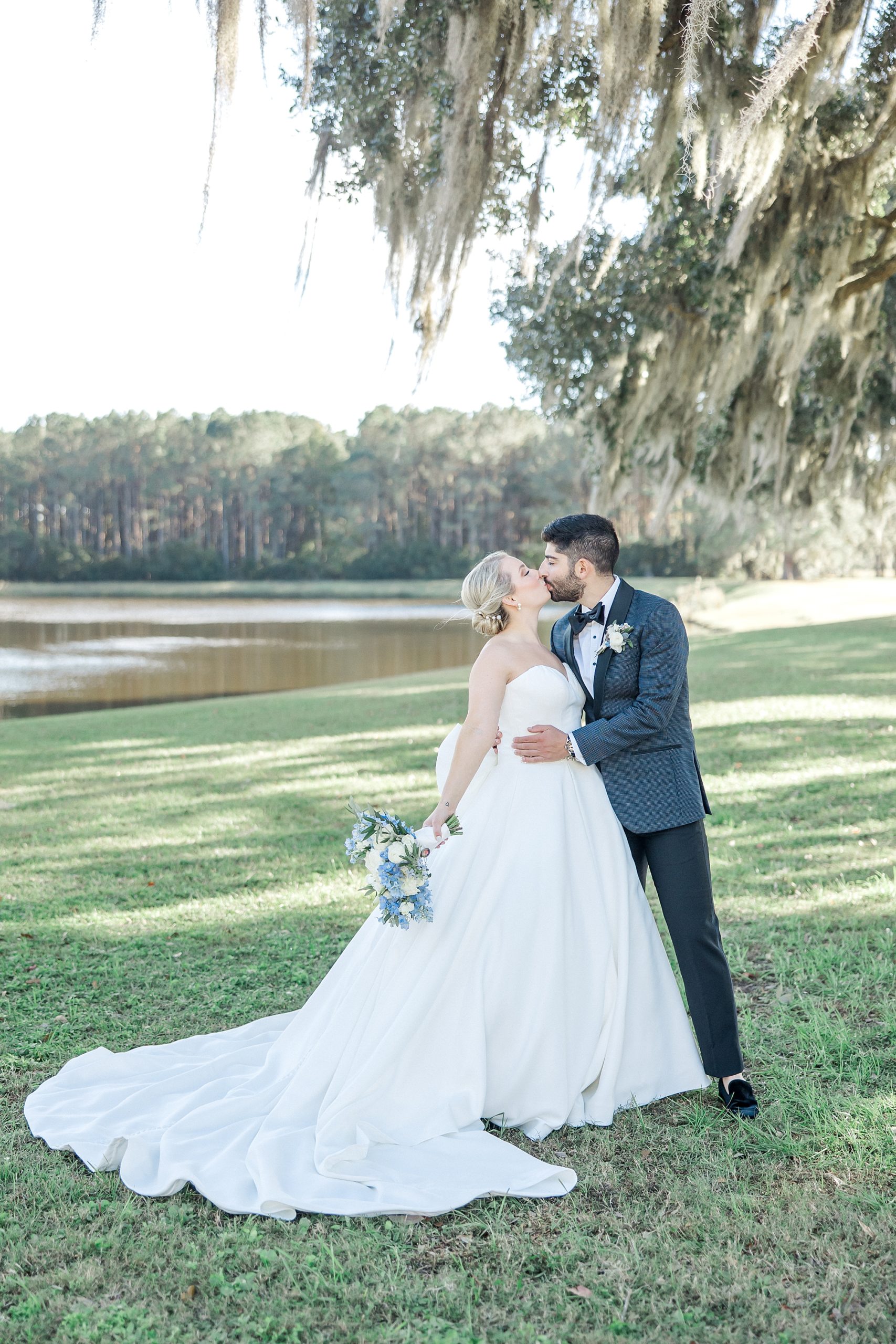 newlyweds kiss under the ancient oak trees in Charleston SC