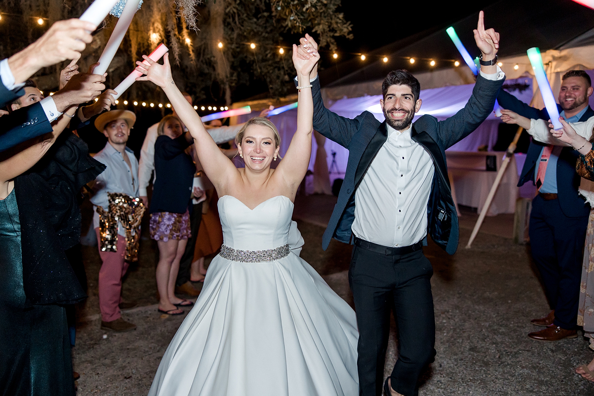 bride and groom celebrate as they exit their wedding reception