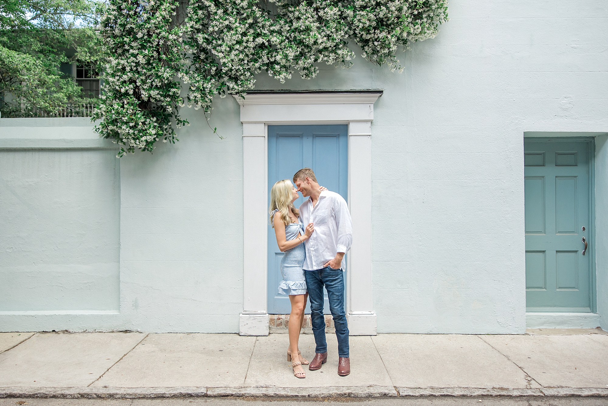 couple in front blue building in Charleston