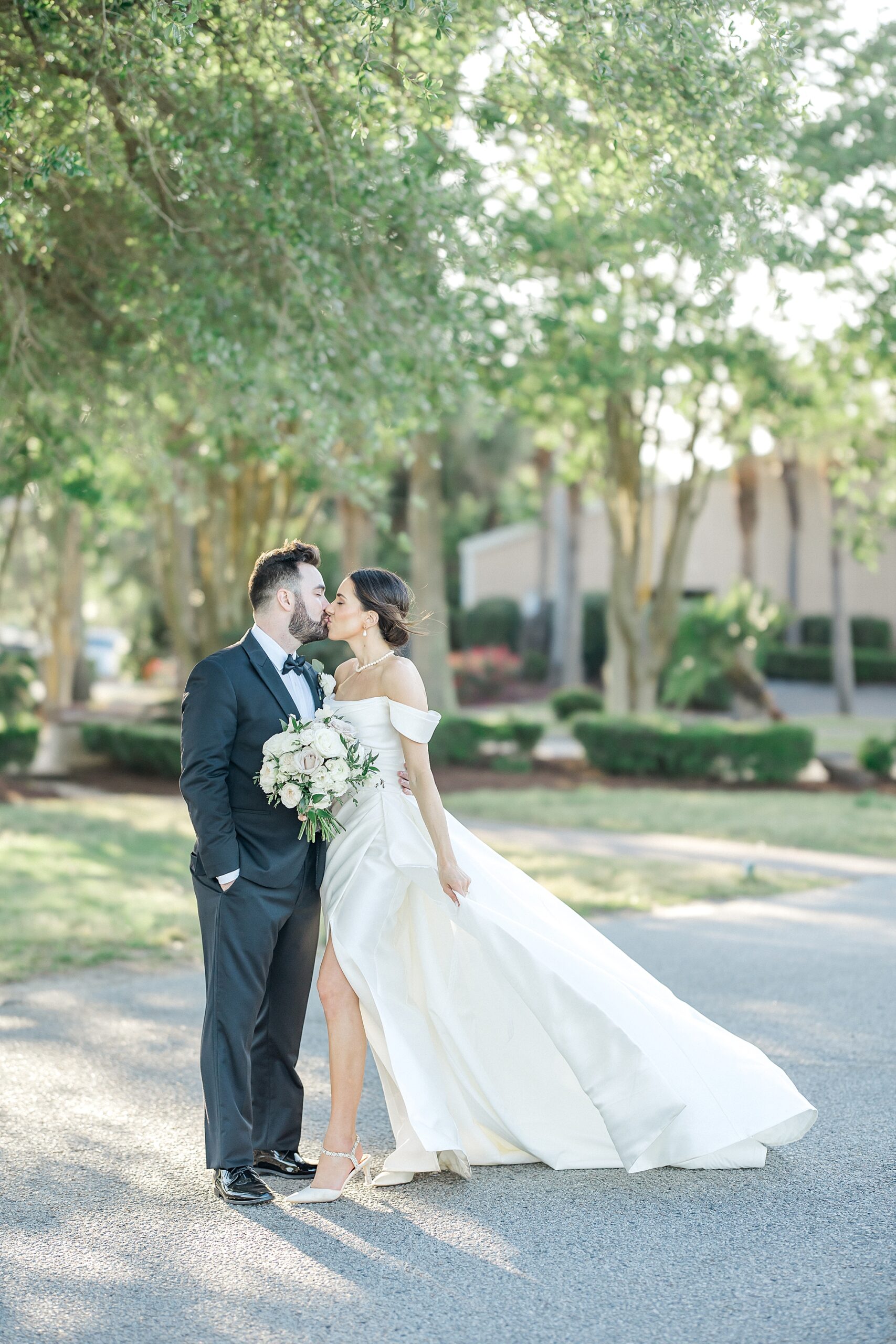 bride and groom kiss at Charleston harbor