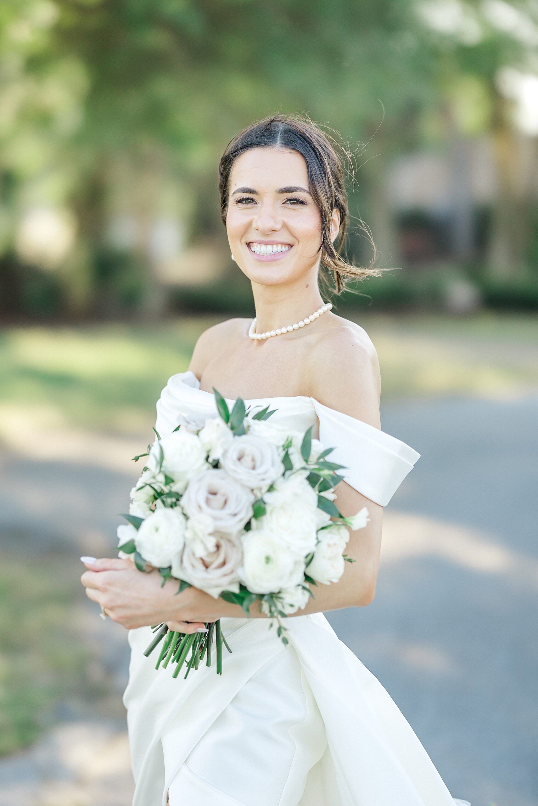 bride in off shoulder dress and classic bridal bouquet