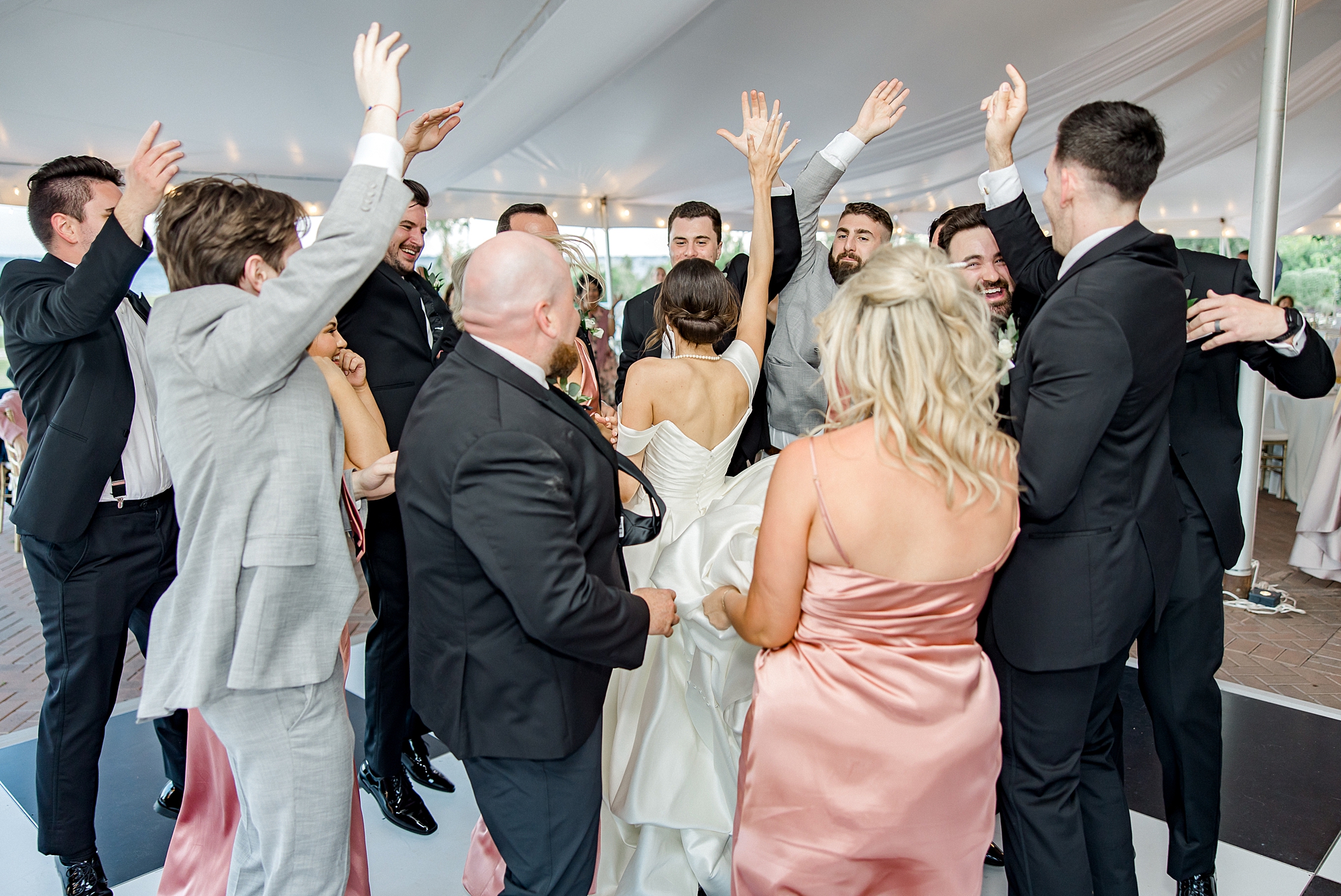 wedding guests surround bride and groom on dance floor