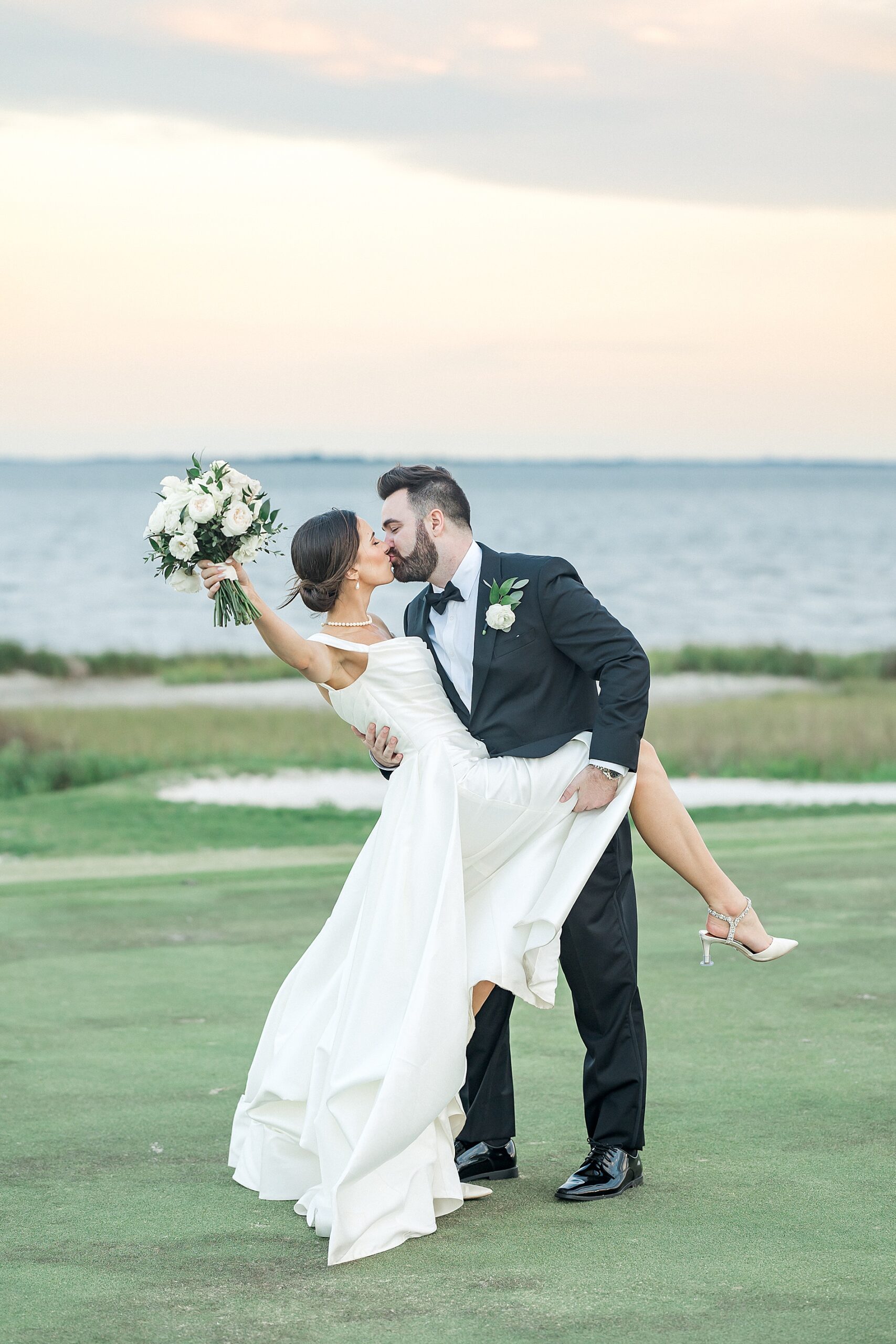 newlyweds kiss during Waterfront Charleston Wedding at Patriots Point Links