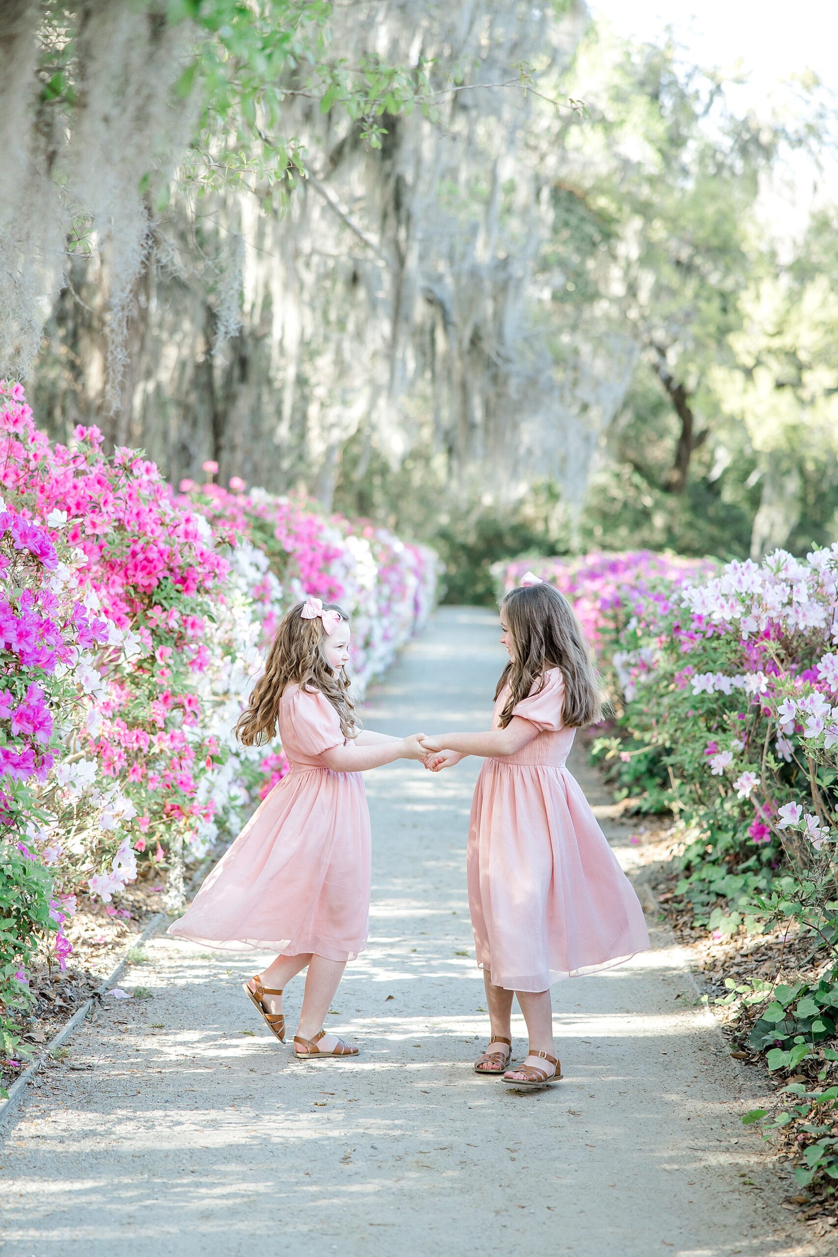 sisters dance in the middle of garden path