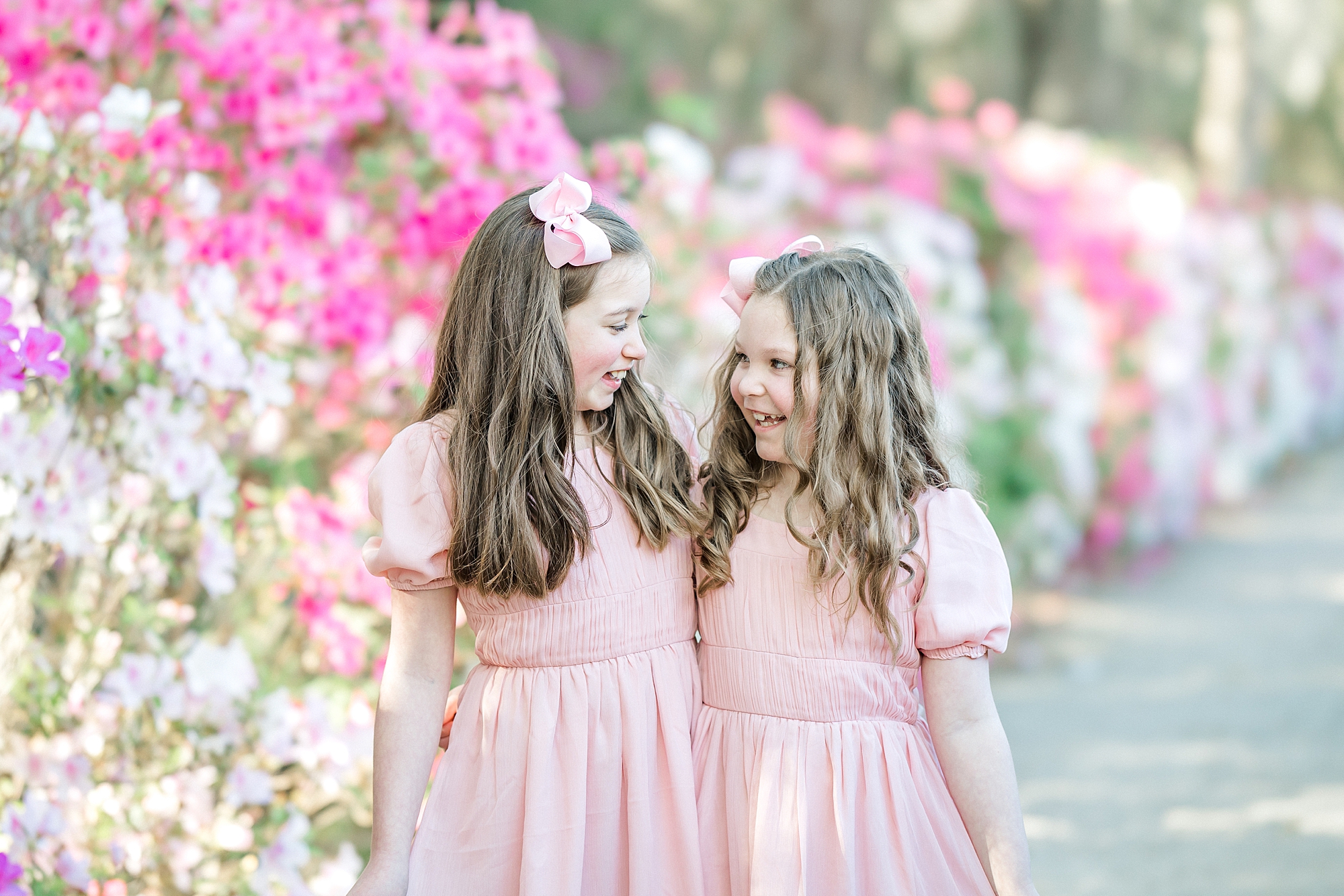 sisters by pink and white azalea blooms