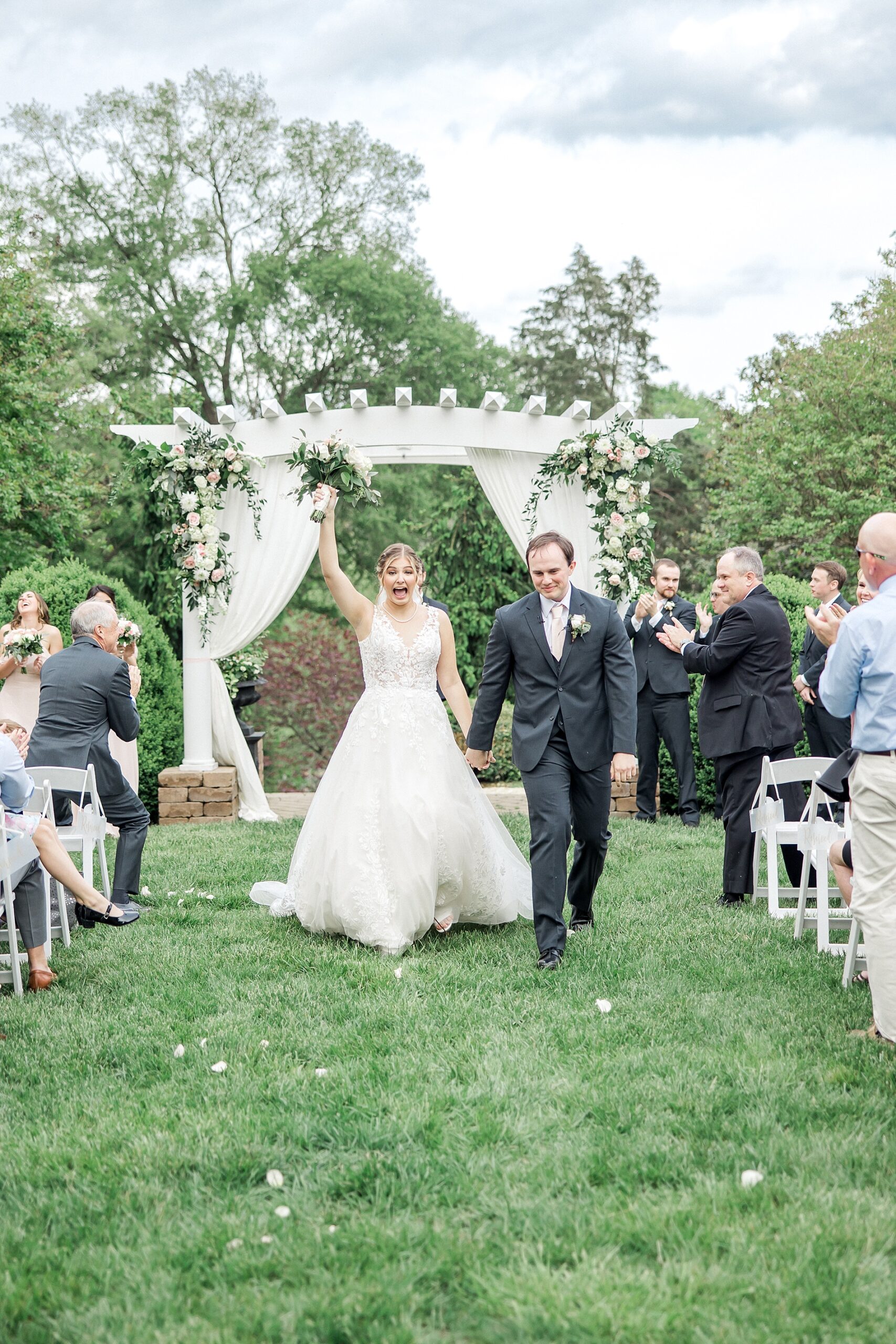 newlyweds exit wedding ceremony in Sunnybrook Wedding venue in Virginia