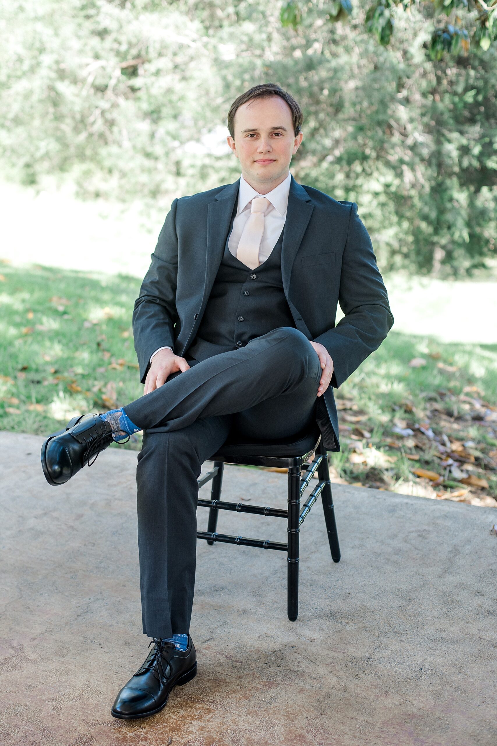 groom sitting in chair outside