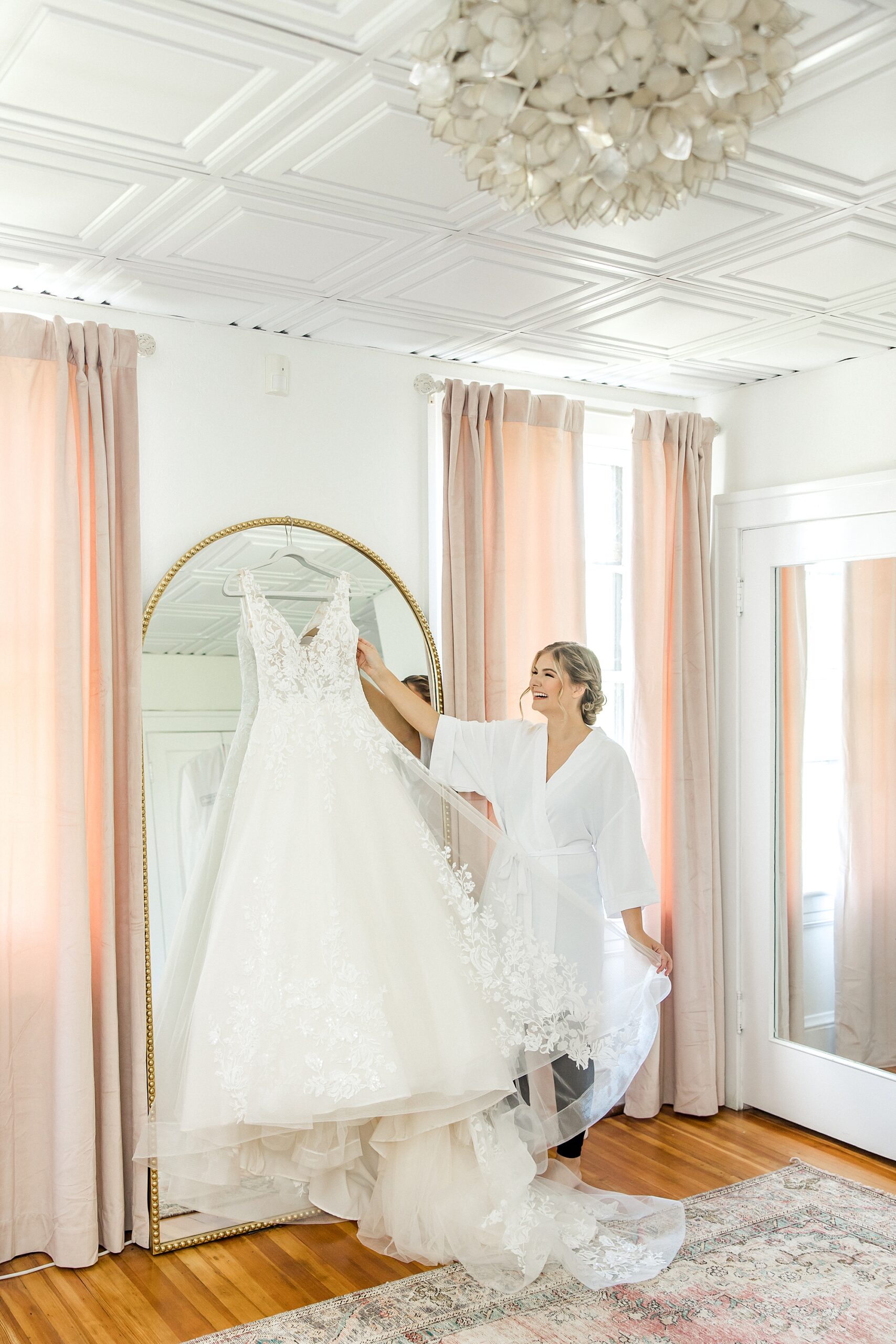 bride admiring wedding dress