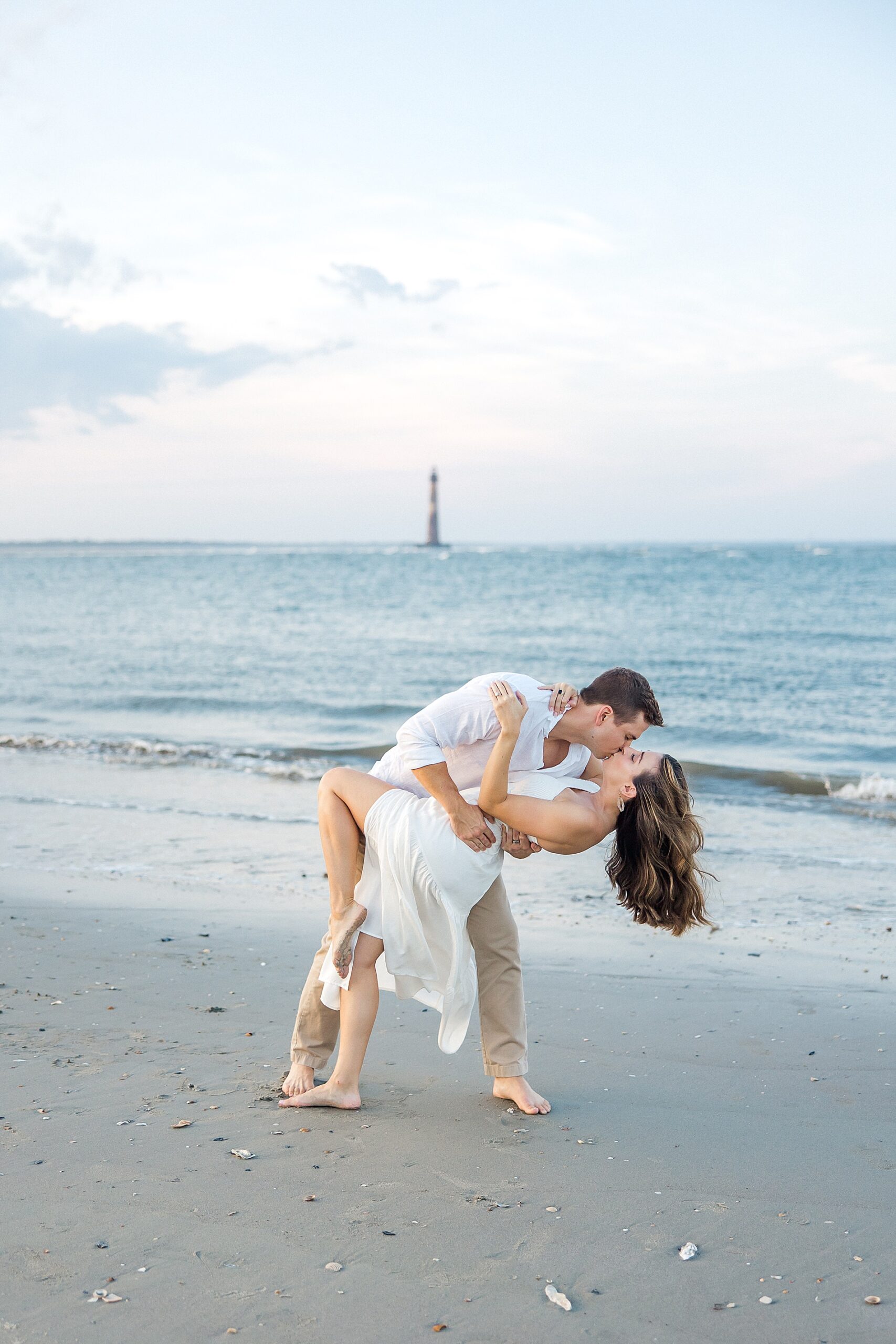 couple kiss on the beach during Folly Beach engagement