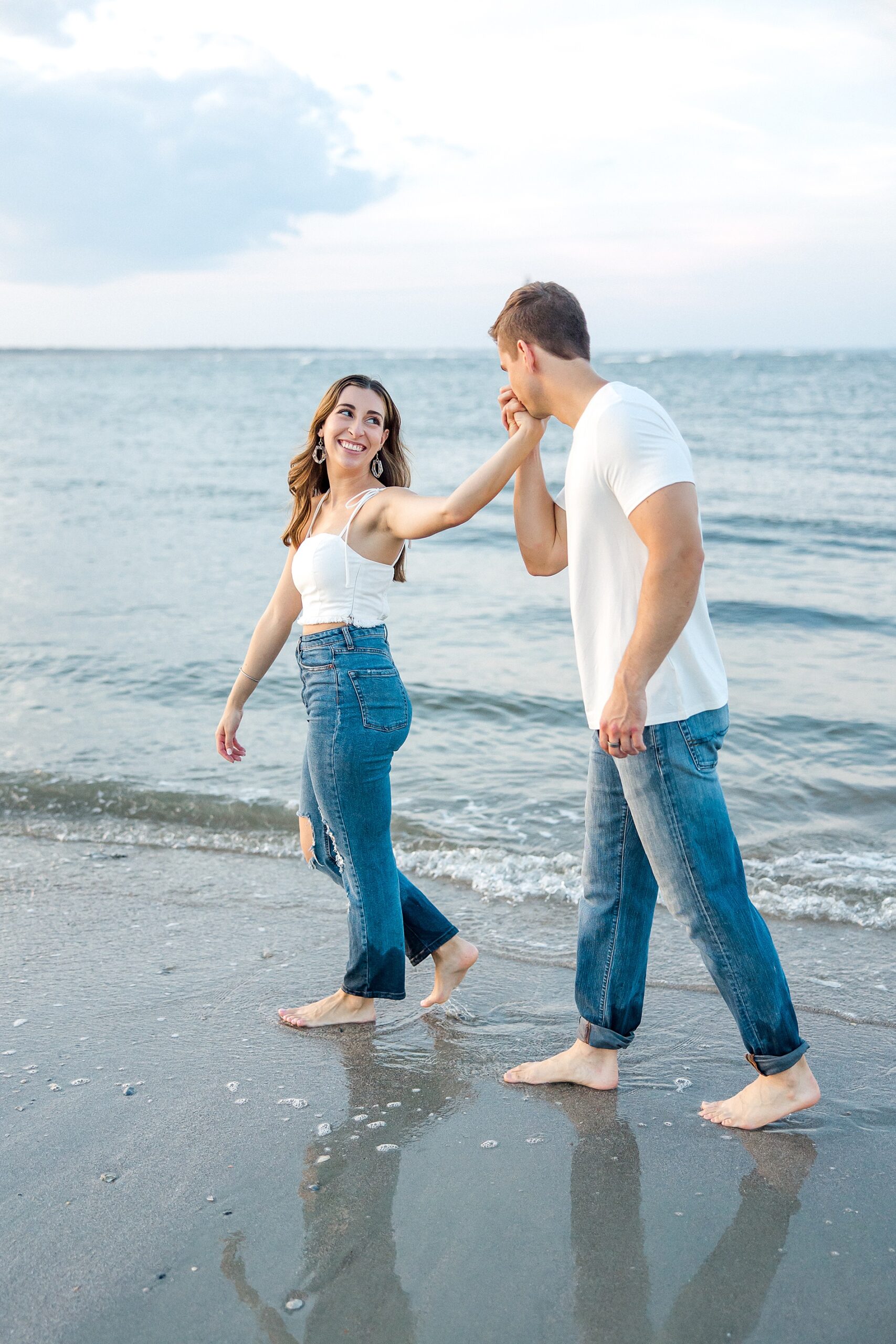 couple walk along the beach during engagement session
