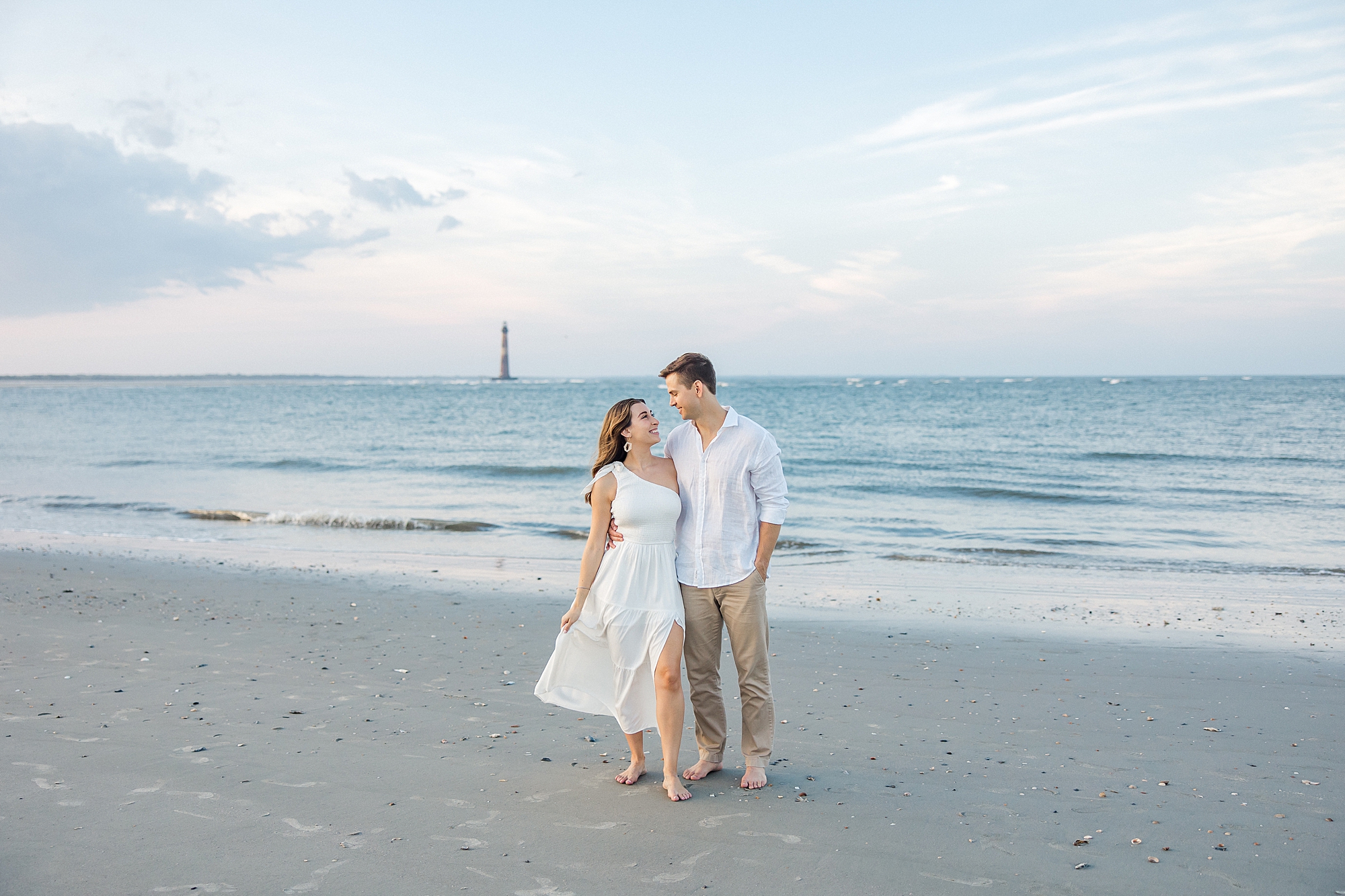 engagement portraits on Folly beach with lighthouse