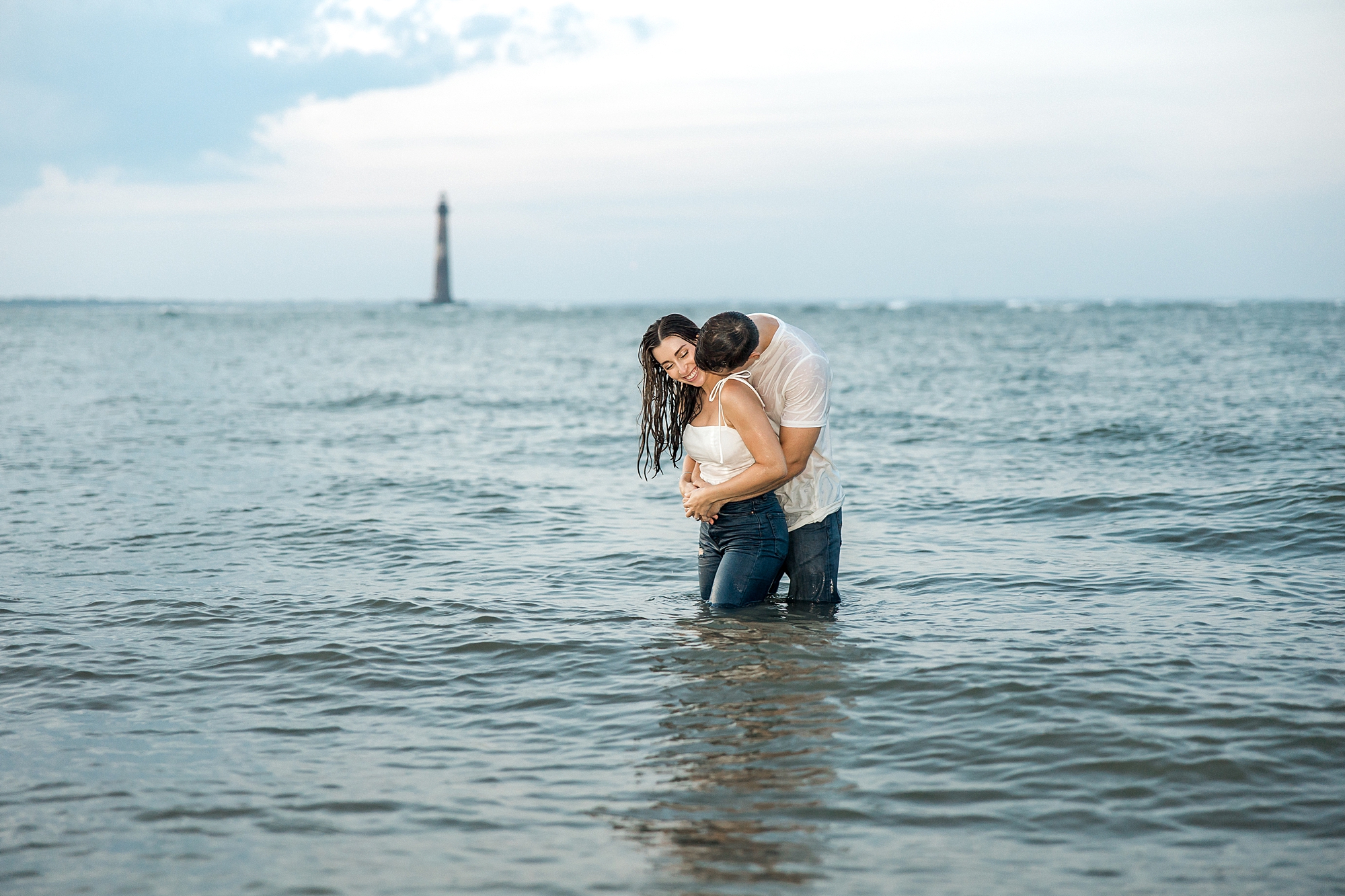couple in the ocean during Folly Beach Engagement in Charleston