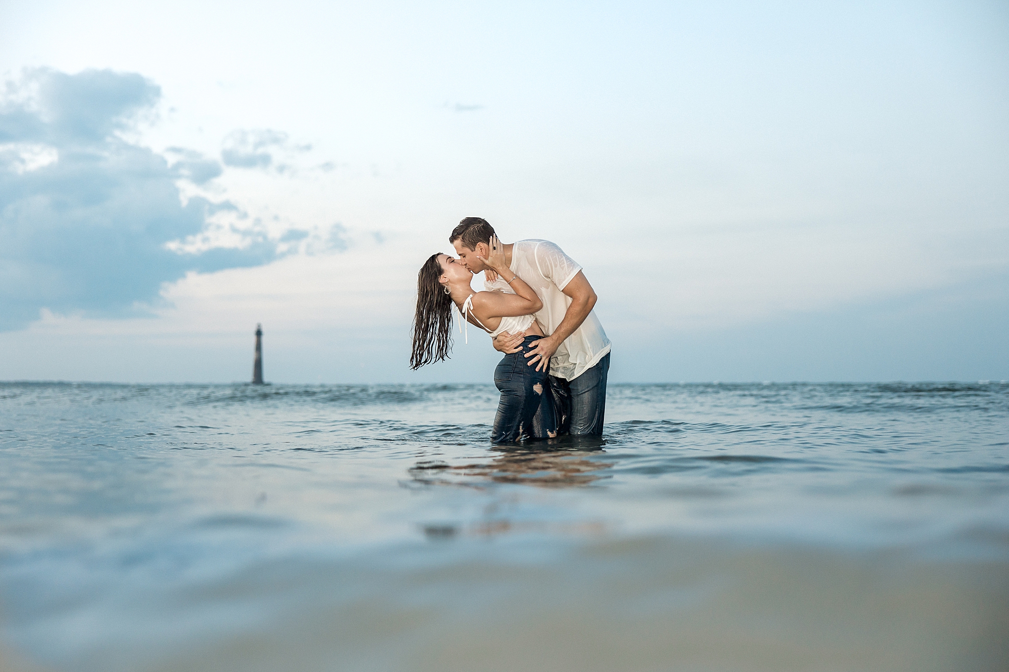 romantic engagement photos of couple in ocean