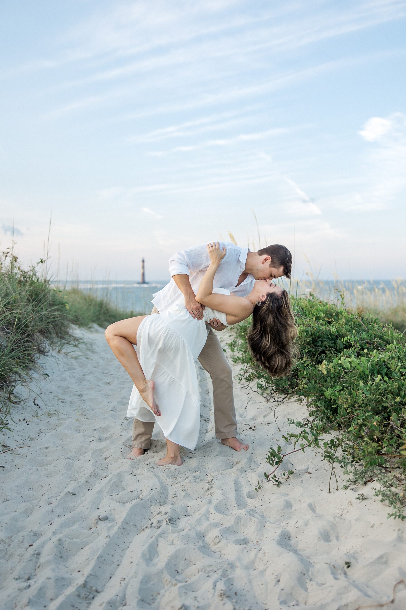 romantic engagement portaits of couple kissing on beach