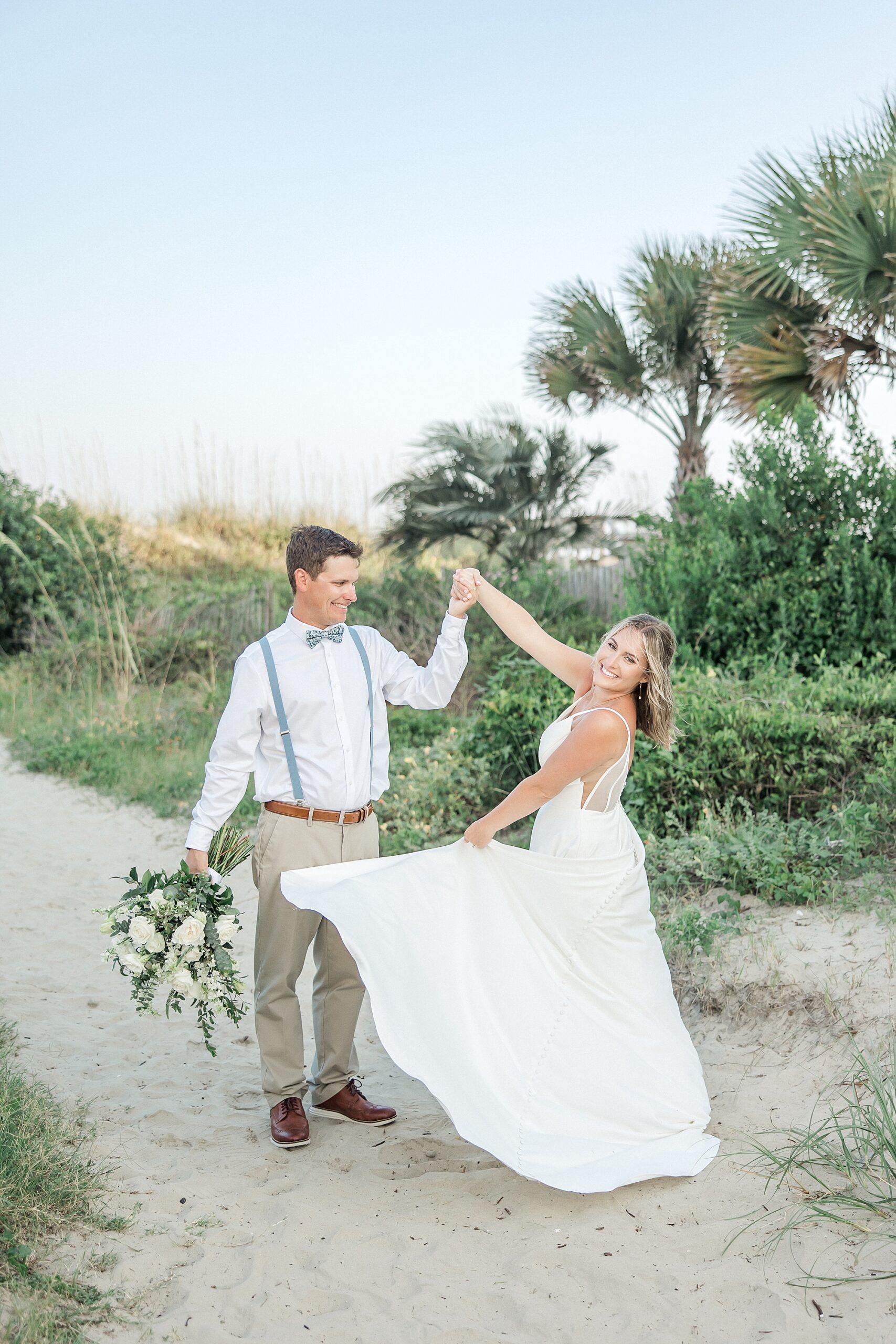 couple dance on the beach during intimate elopement