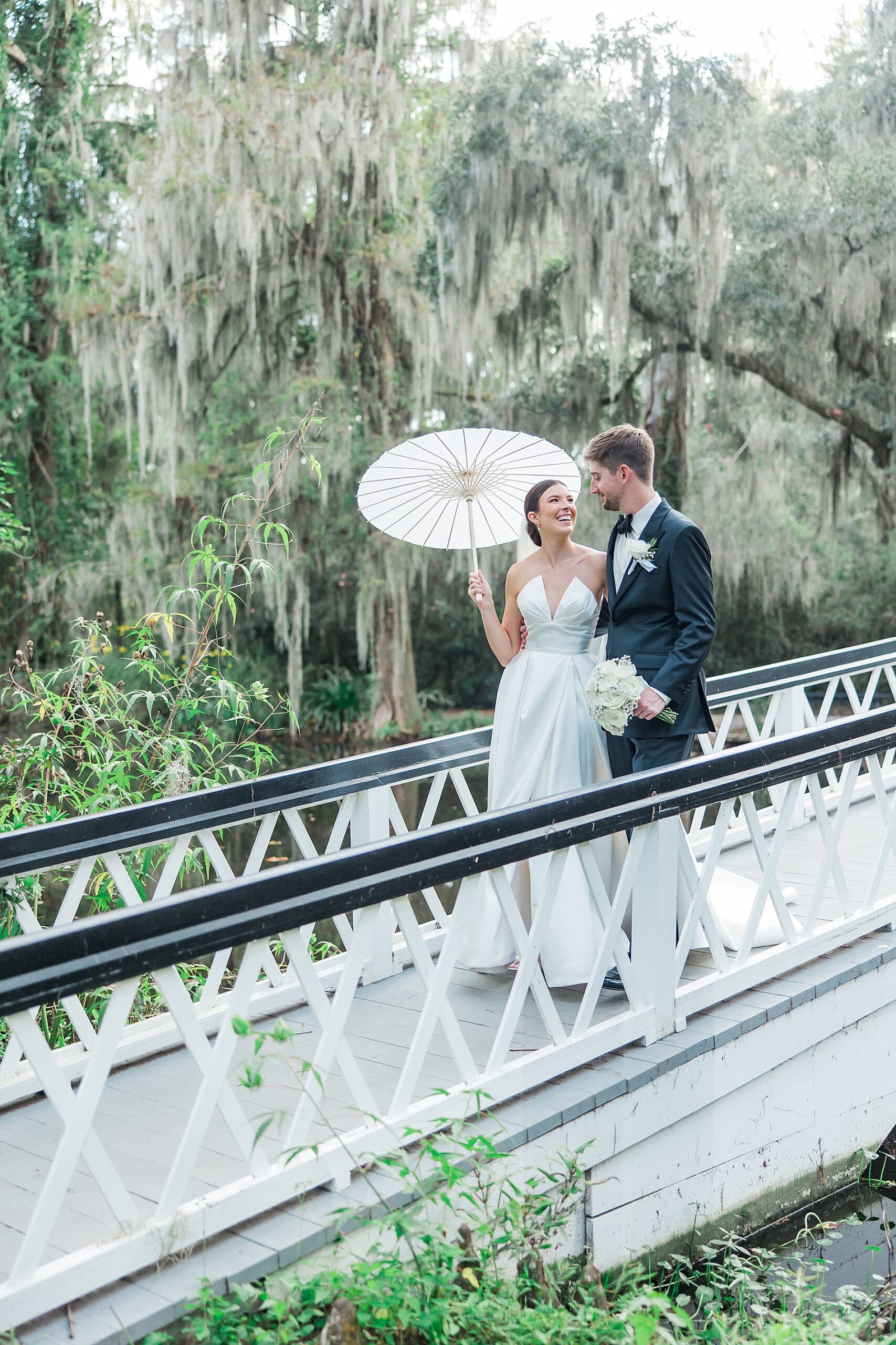 newlyweds photos at iconic white bridge at Magnolia Plantation and Gardens