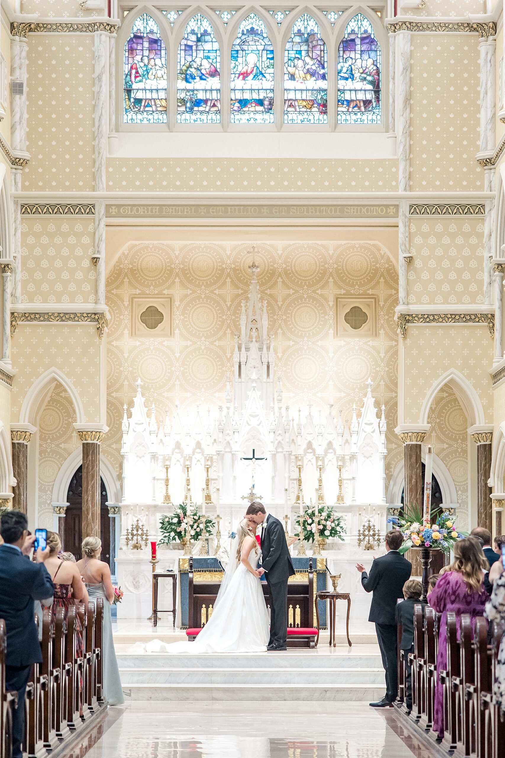 bride and groom kiss during wedding ceremony