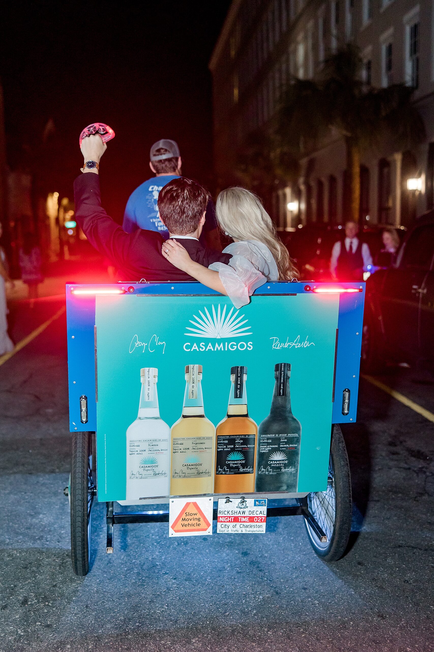 newlyweds are whisked away on a pedicab after elegant spring wedding