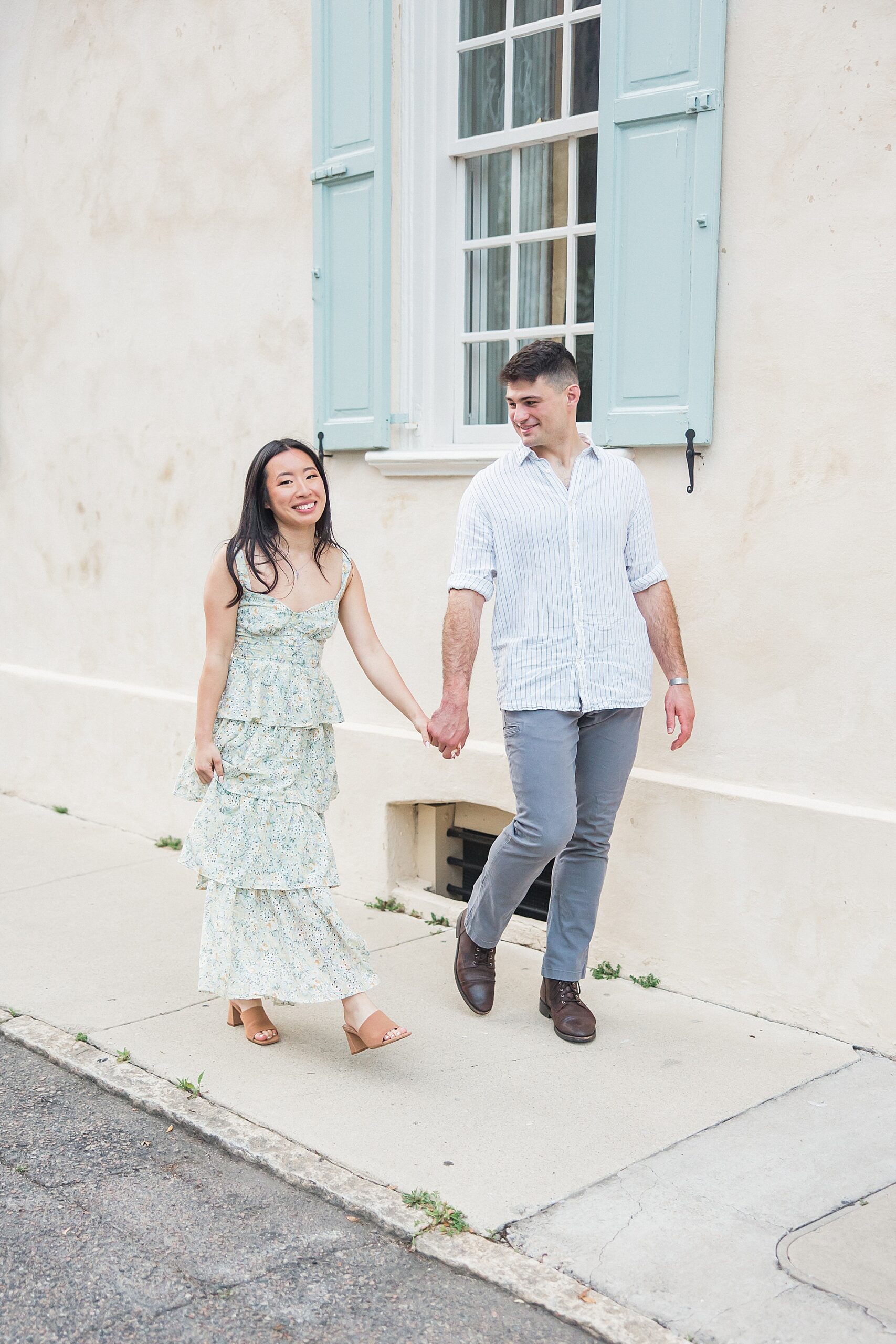 couple hold hands on Charleston street