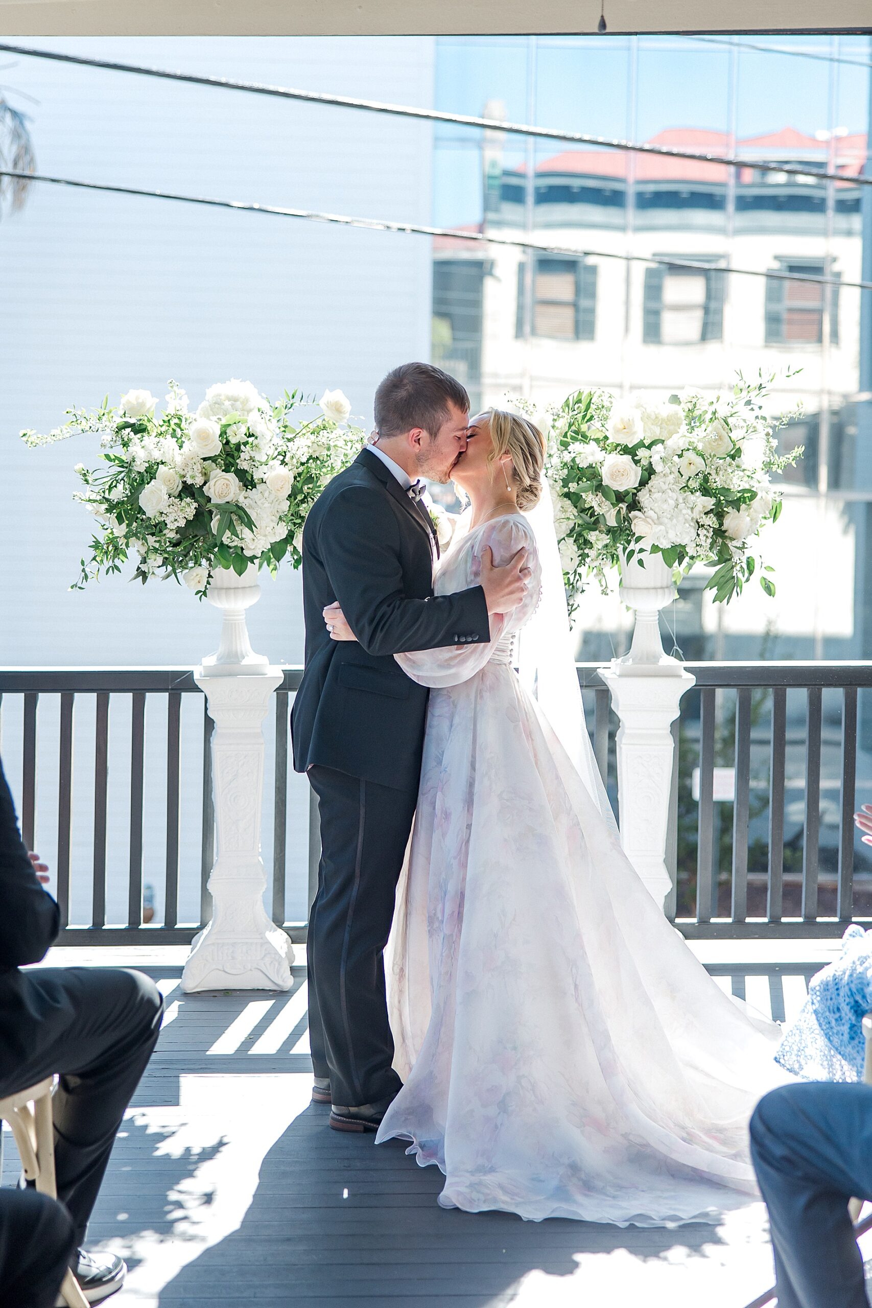 couple kiss during wedding ceremony