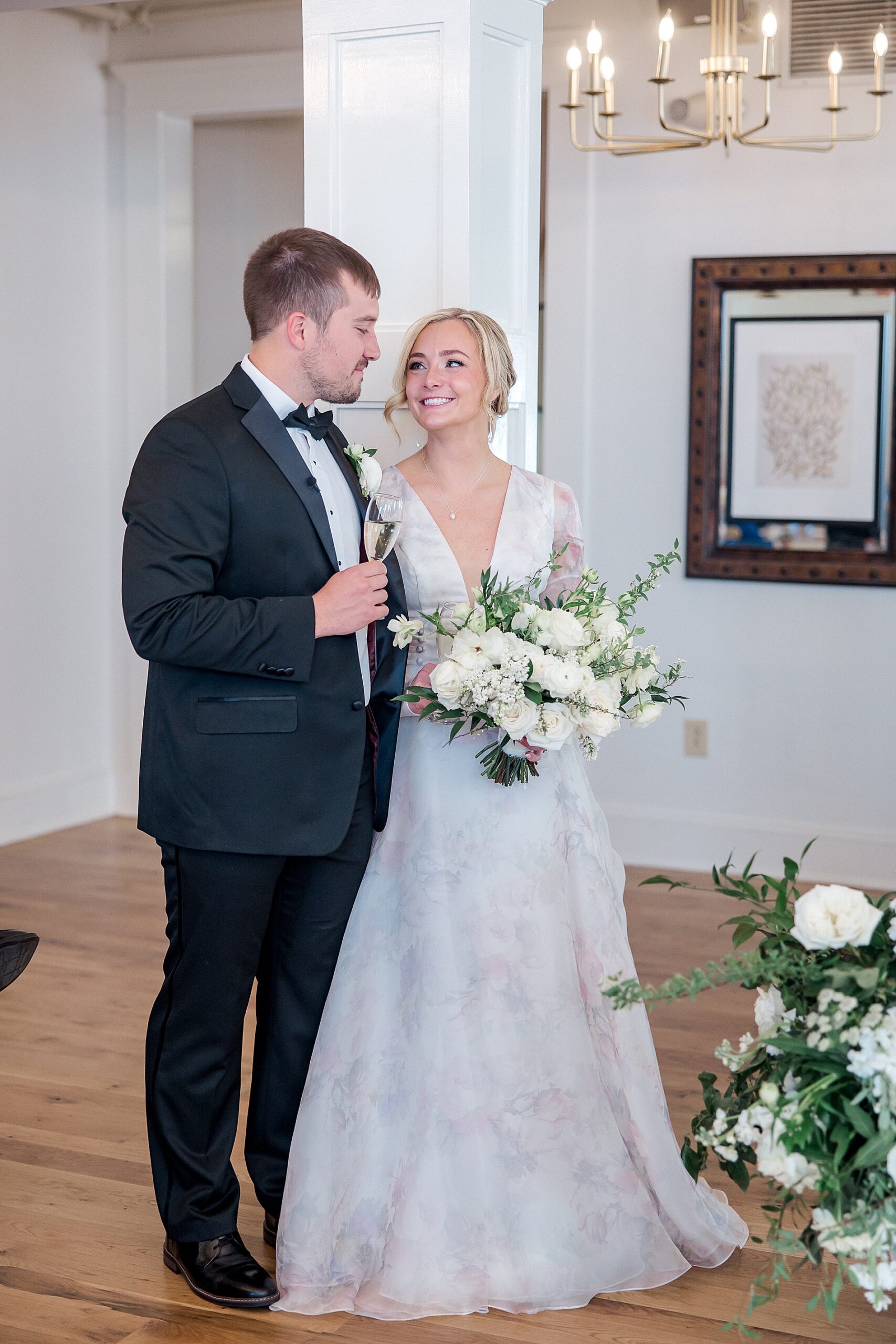 couple look at each other during wedding toast