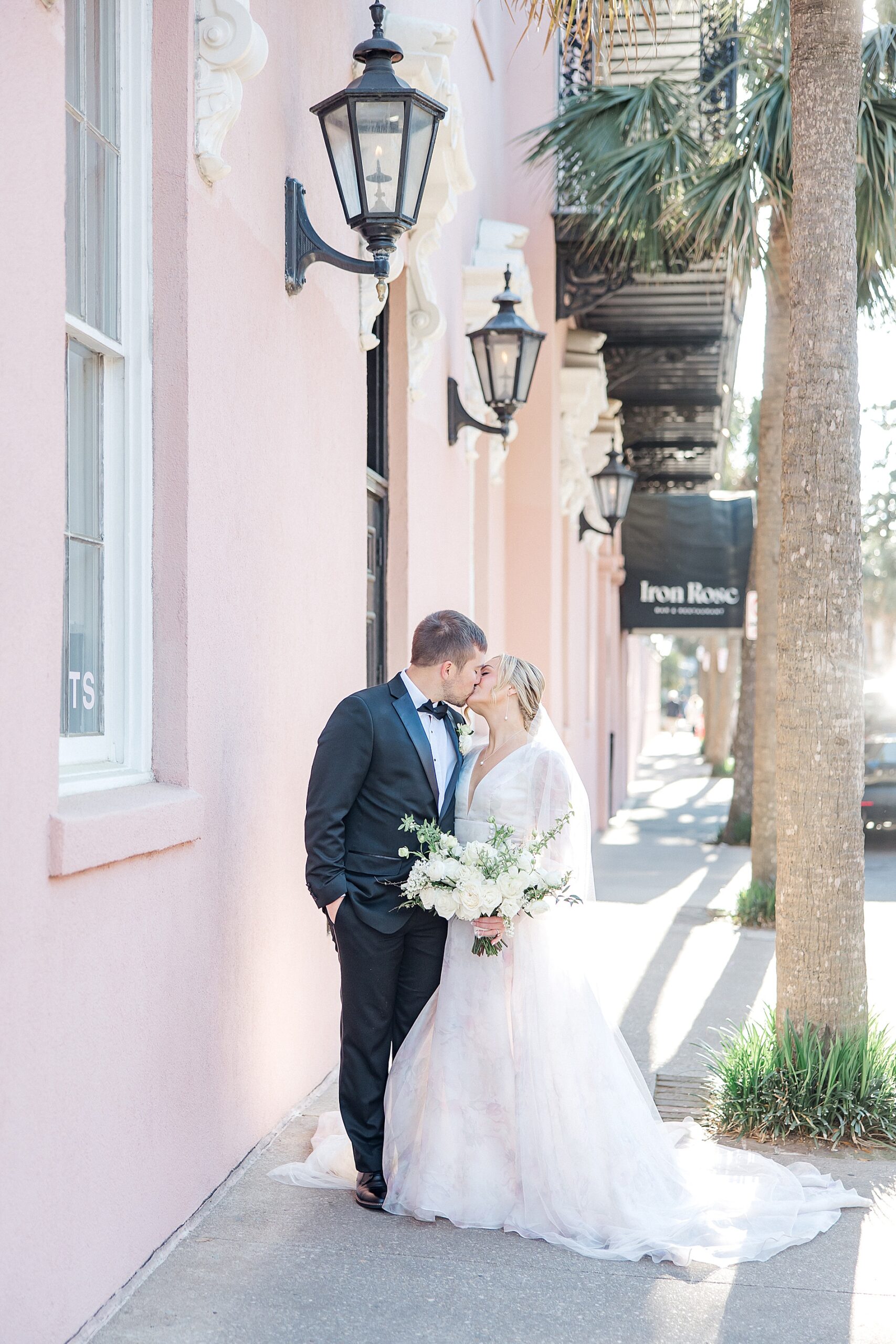 bride and groom kiss on the street