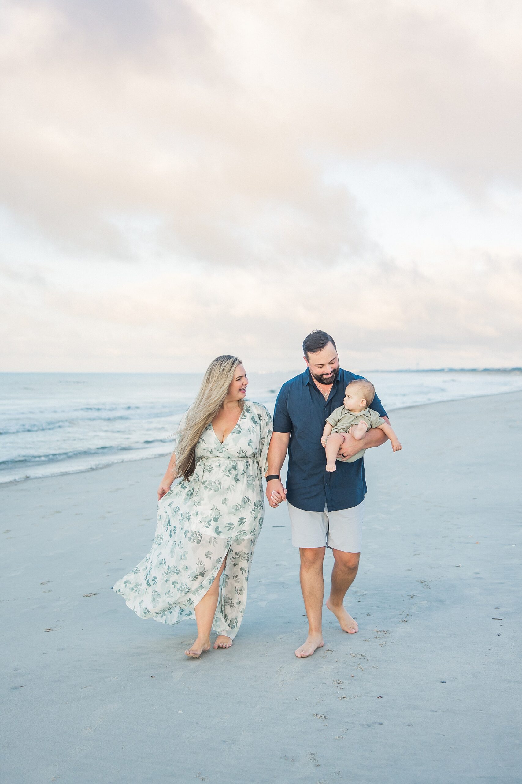 family walks across the beach