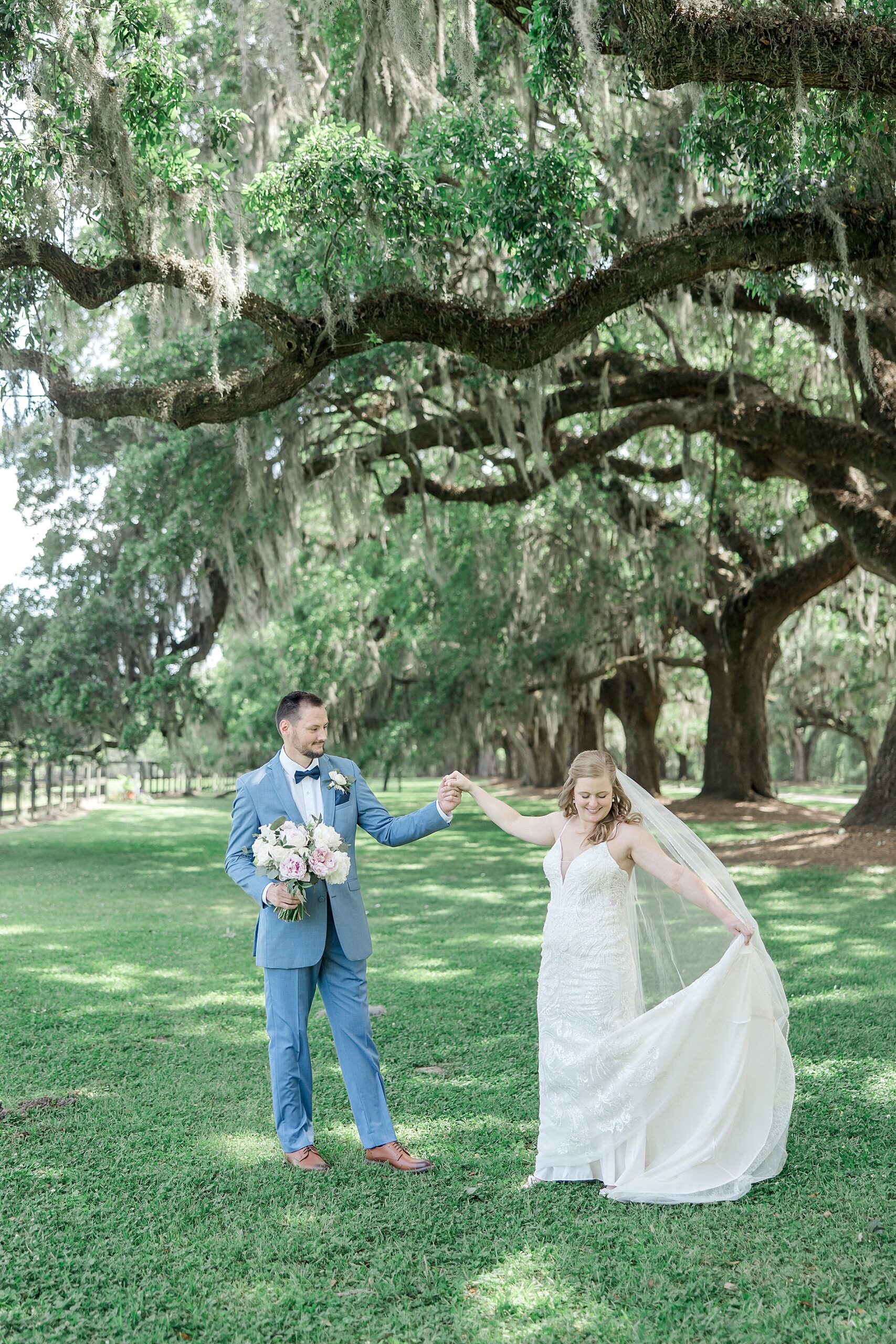 couple dance under oak trees in Charleston, SC