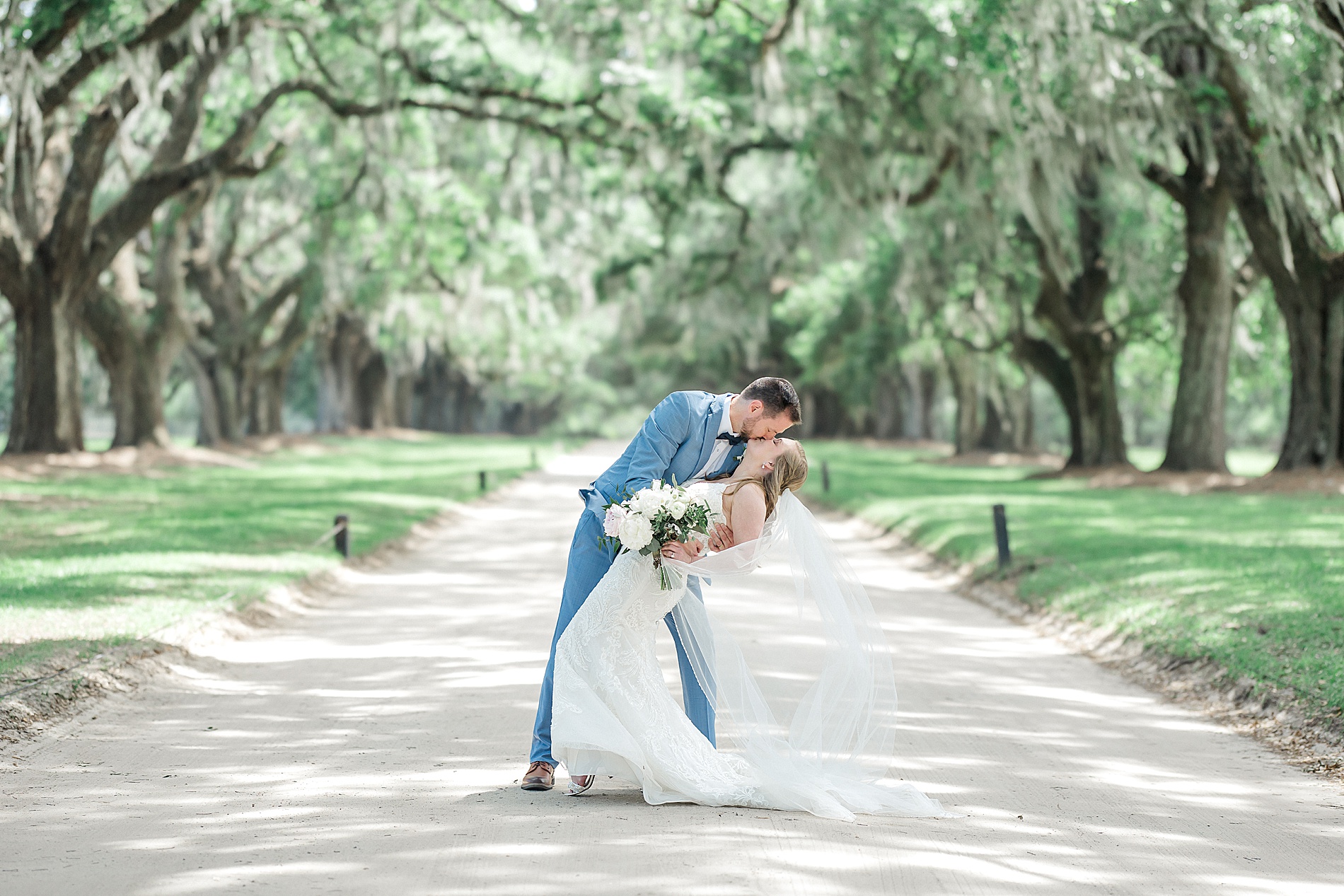 newlywed kiss under oak trees