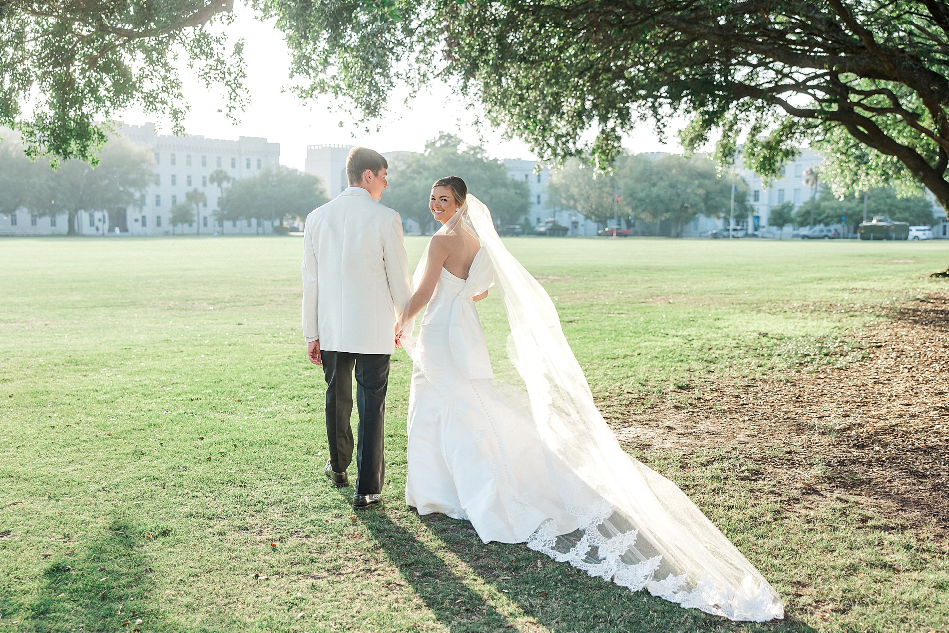 newlyweds walk together holding hands