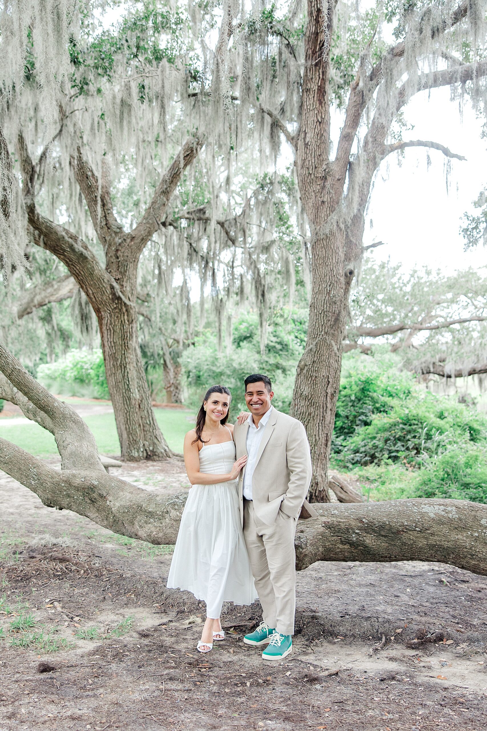 couple stand by large oak tree