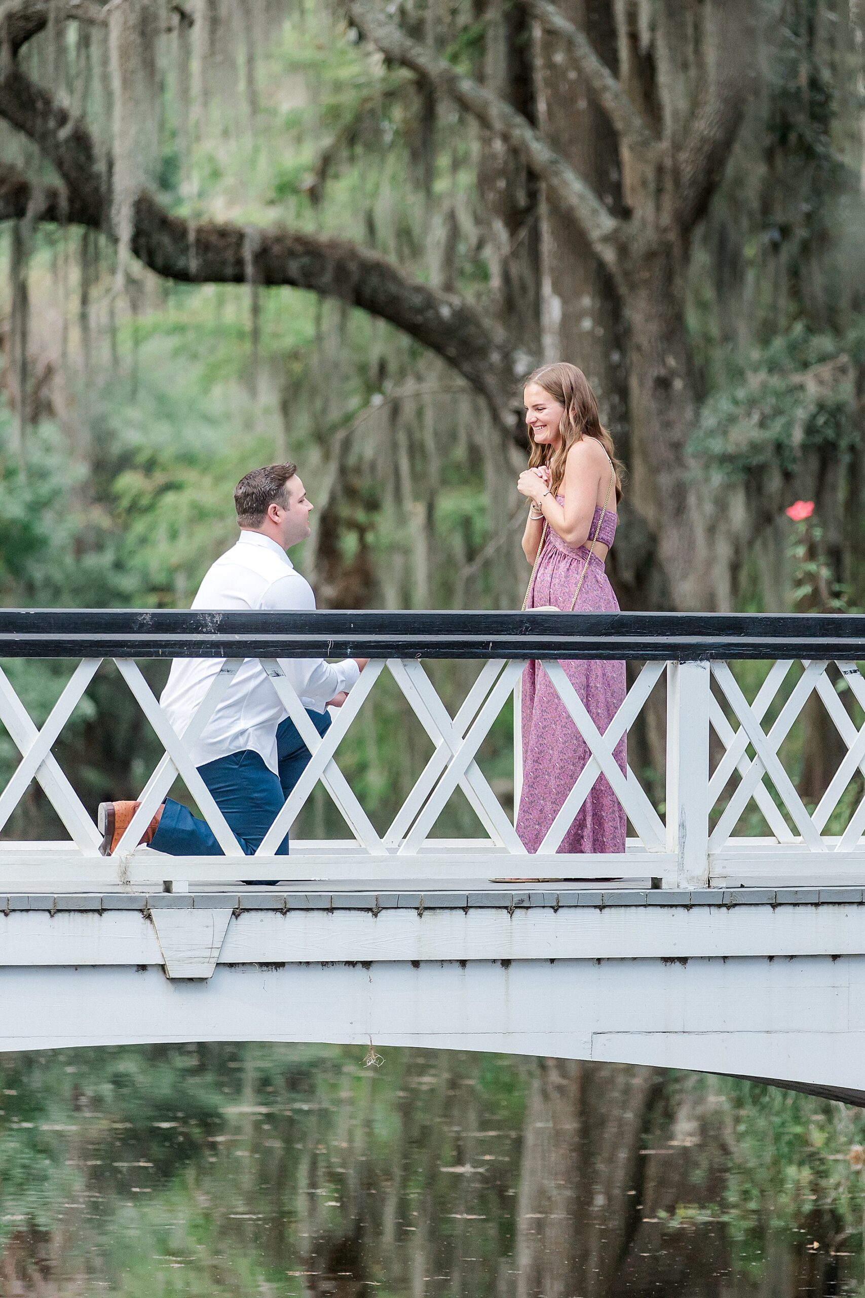 sweet proposal on white bridge at Magnolia Plantation
