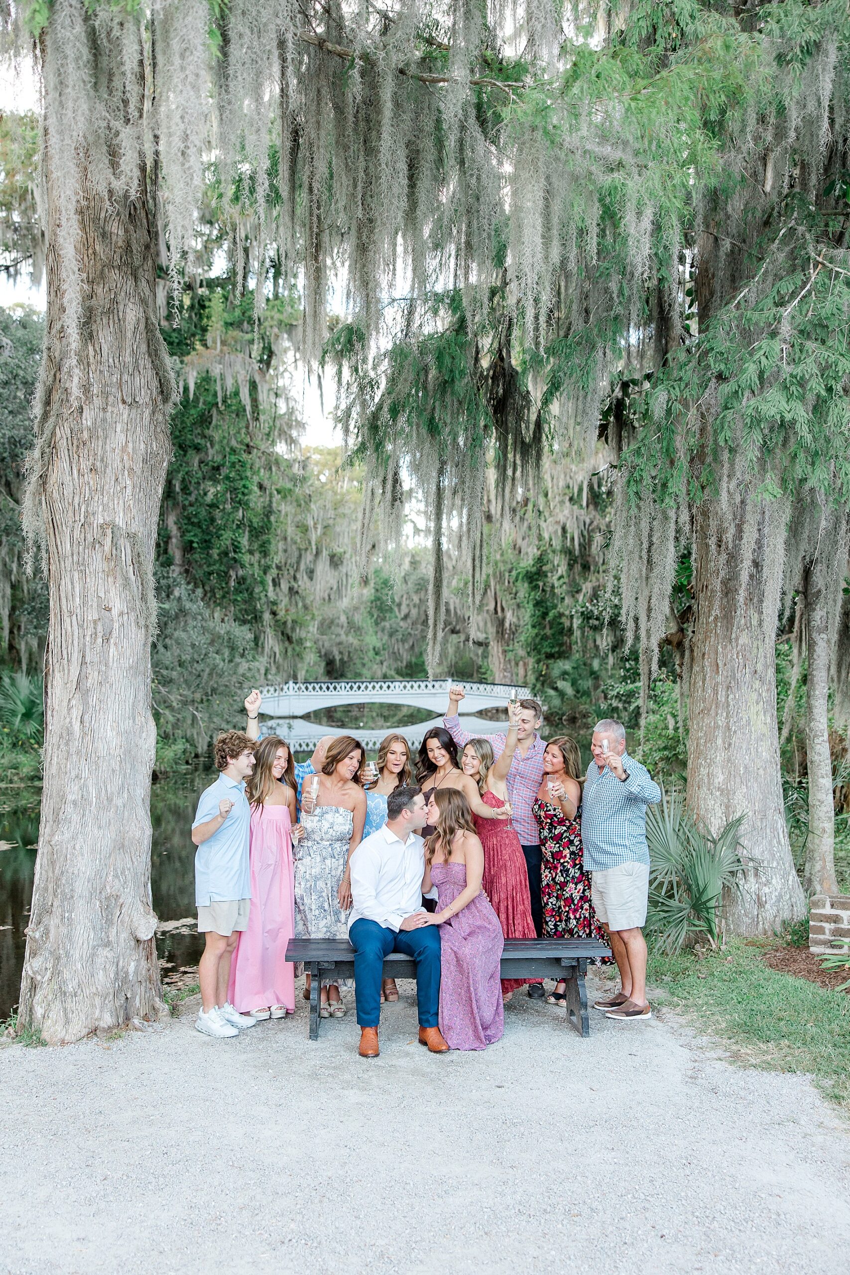 family and friends celebrate newly engaged couple
