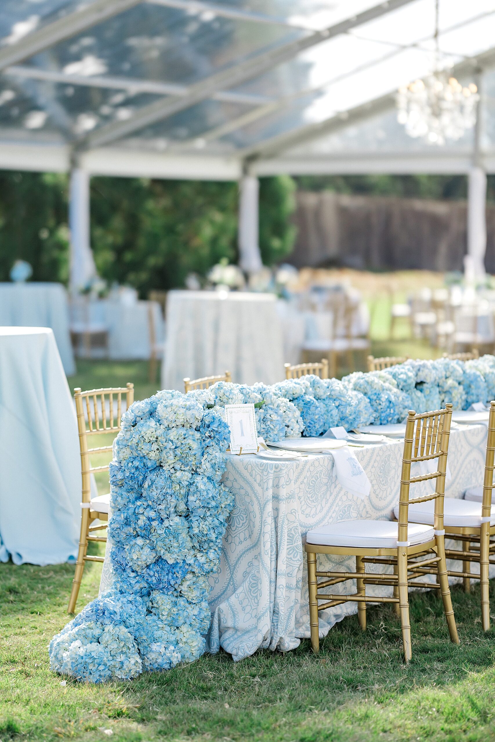 southern wedding details with blue hydrangeas lining center of table