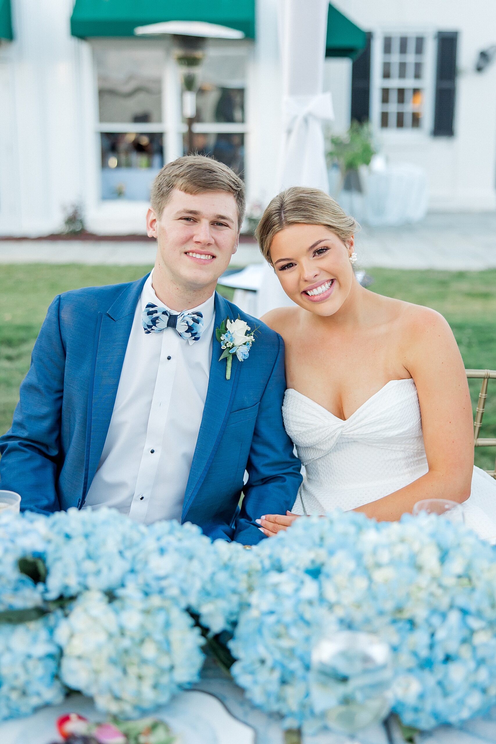 bride and groom sit together at reception